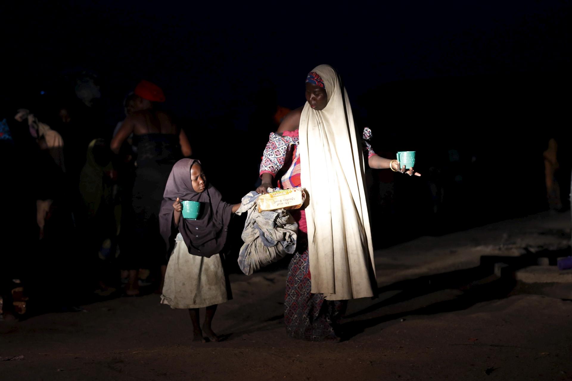 A girl and her mother rescued from Boko Haram in Sambisa Forest by Nigeria's military arrive at a camp for the displaced. 