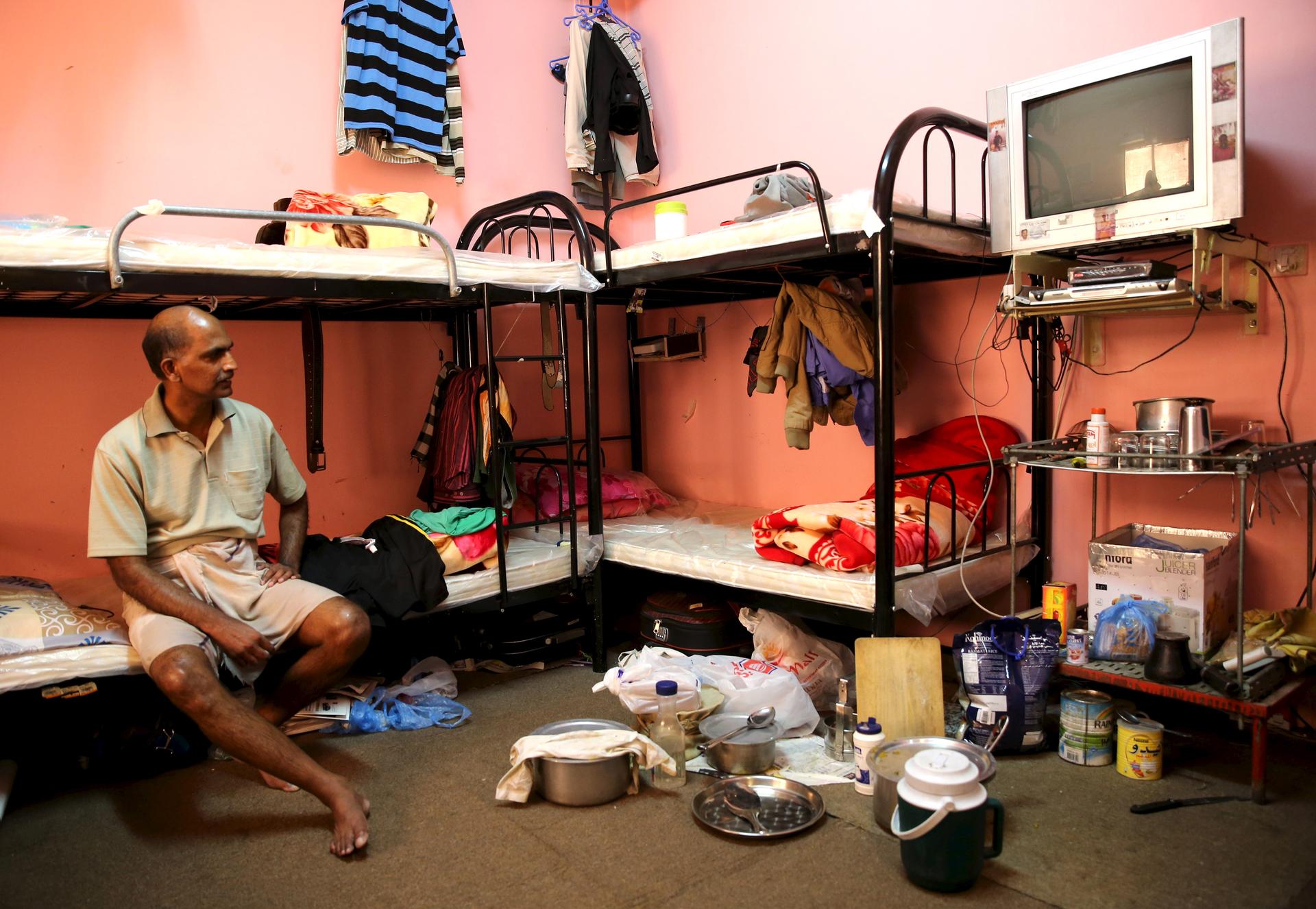 A laborer rests in a dormitory for foreign workers in the Sanaya Industrial Area in Doha during a government-guided tour, on May 3, 2015.