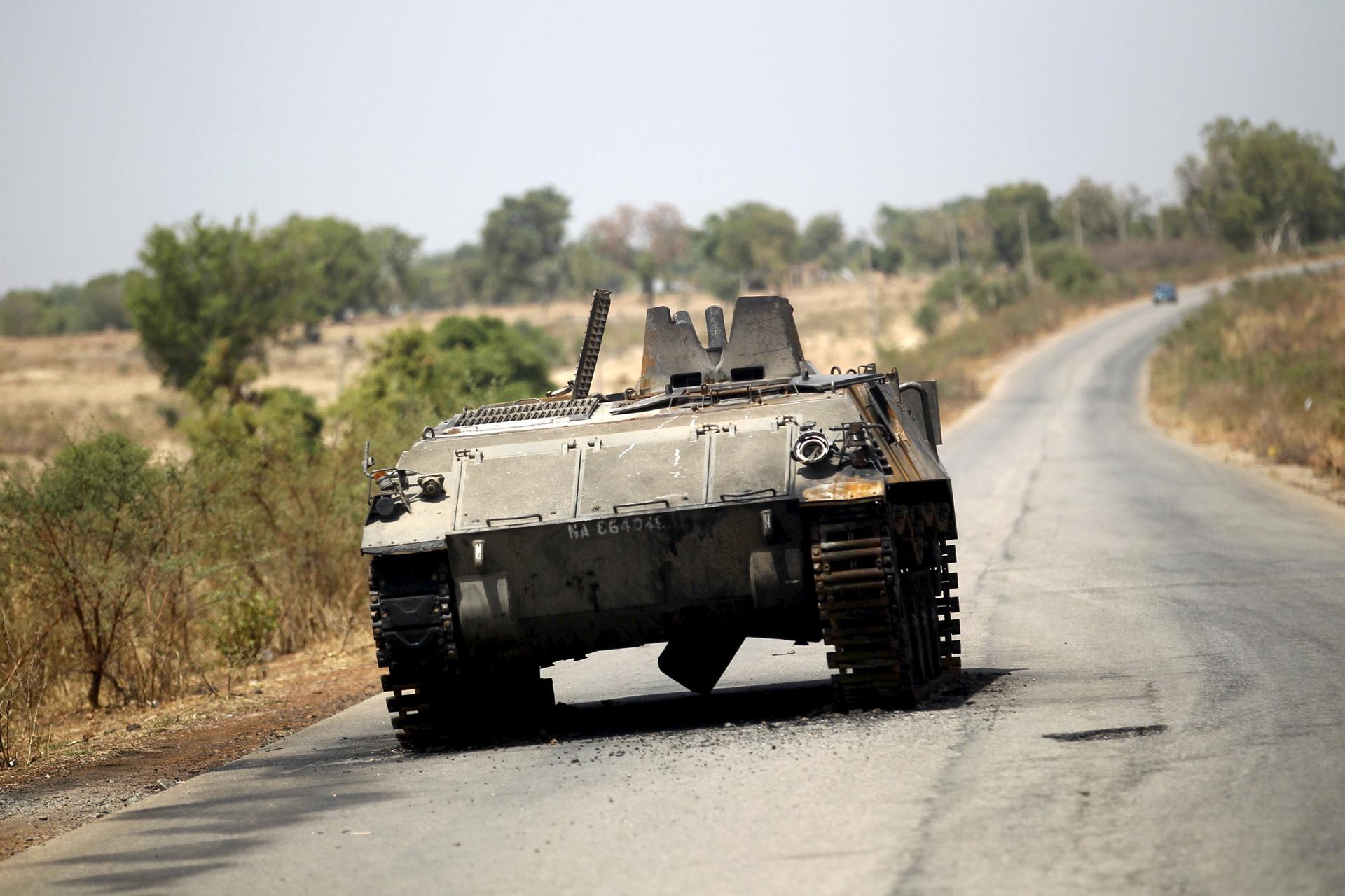 A military armoured tank is seen abandoned along a road after the Nigerian military recaptures the town of Michika from Boko Haram, Adamawa state May 10, 2015.