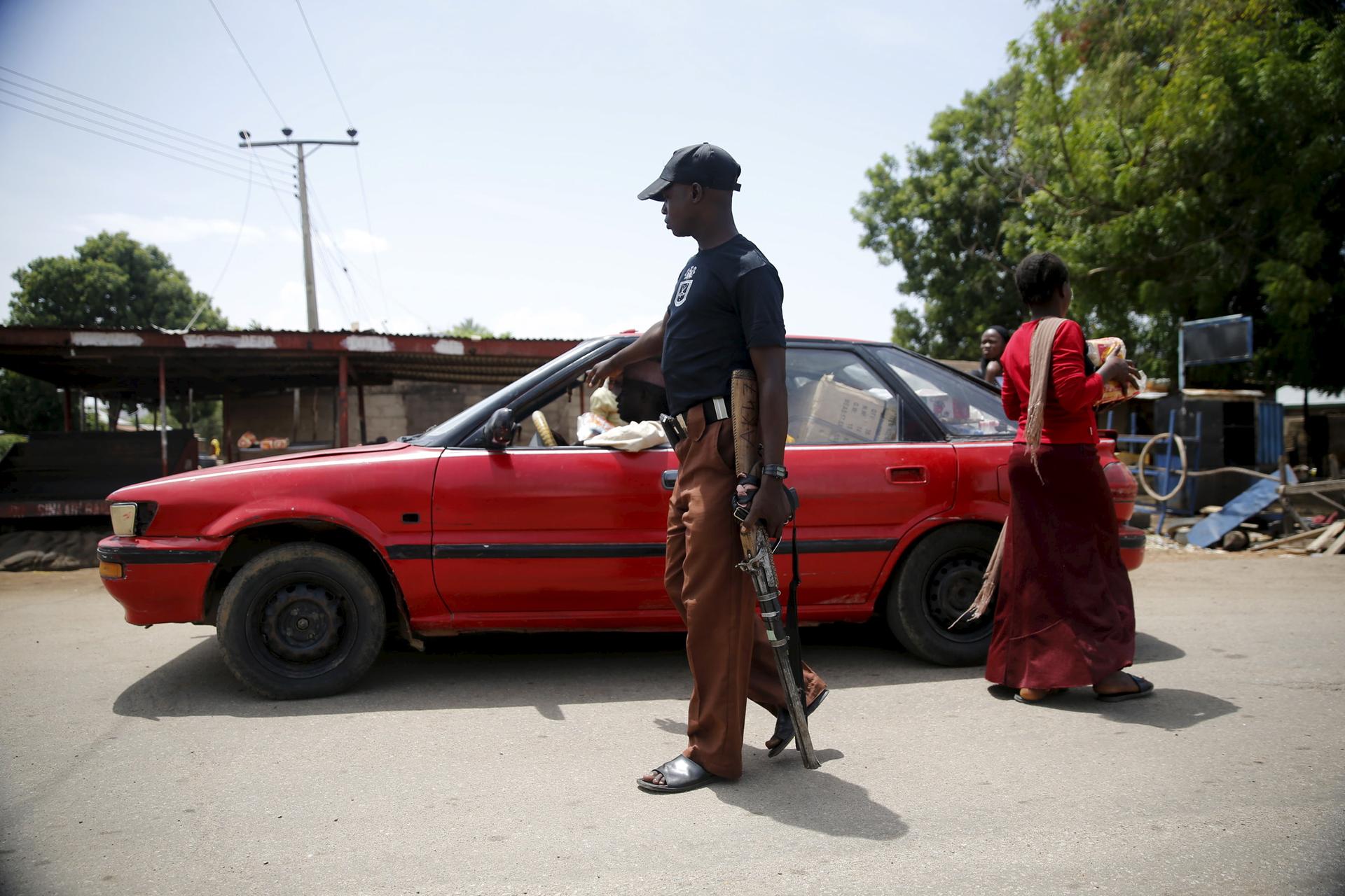A local vigilante checks a vehicle at a check point in Michika town, after the Nigerian military recaptured it from Boko Haram, in Adamawa state May 10, 2015. 
