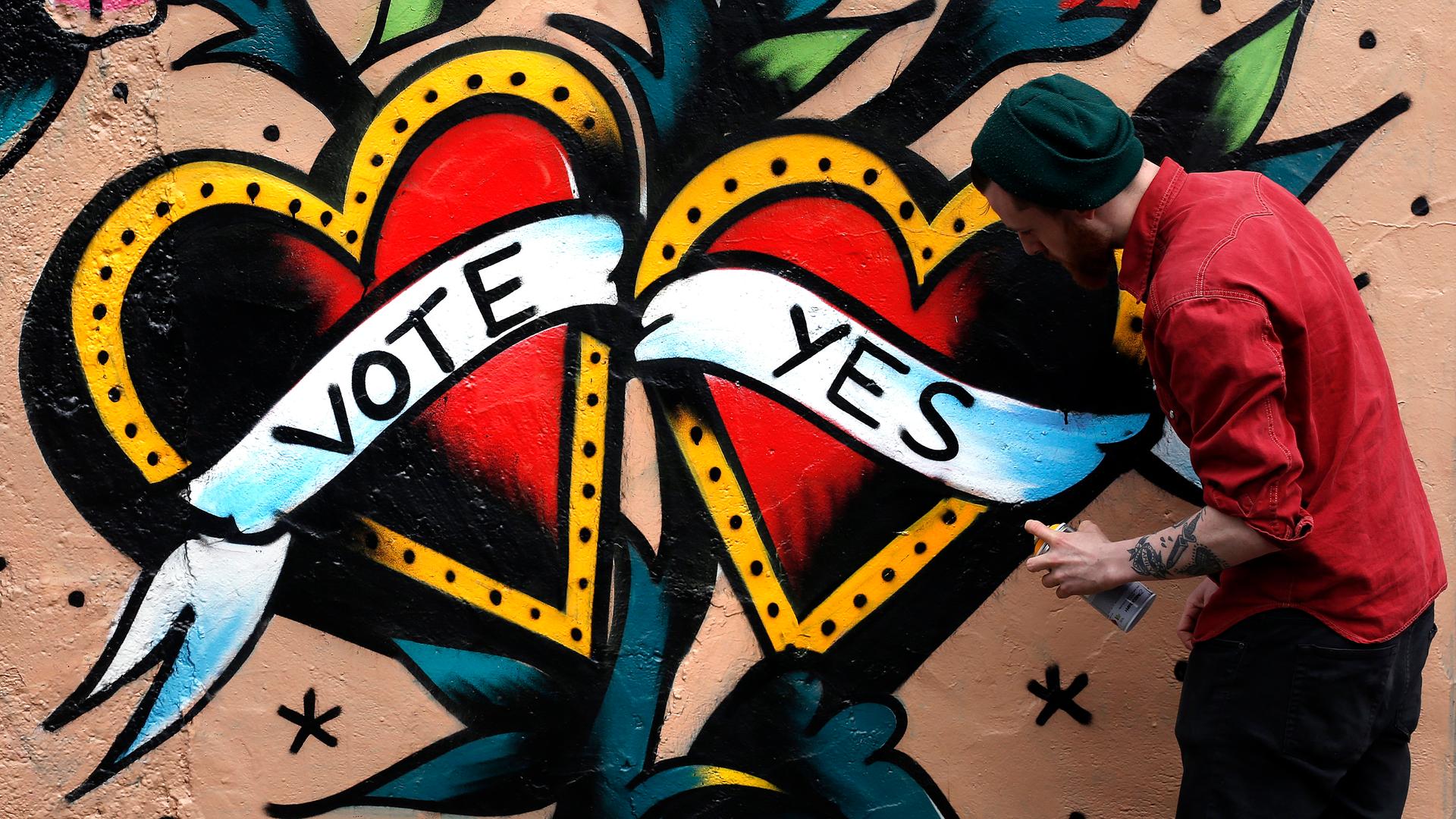 A graffiti artist finishes a Yes campaign piece in central Dublin on May 20, 2015. Irish Prime Minister Enda Kenny said that Ireland must seize its opportunity to become the first country to approve same-sex marriage in a popular vote when it holds a refe
