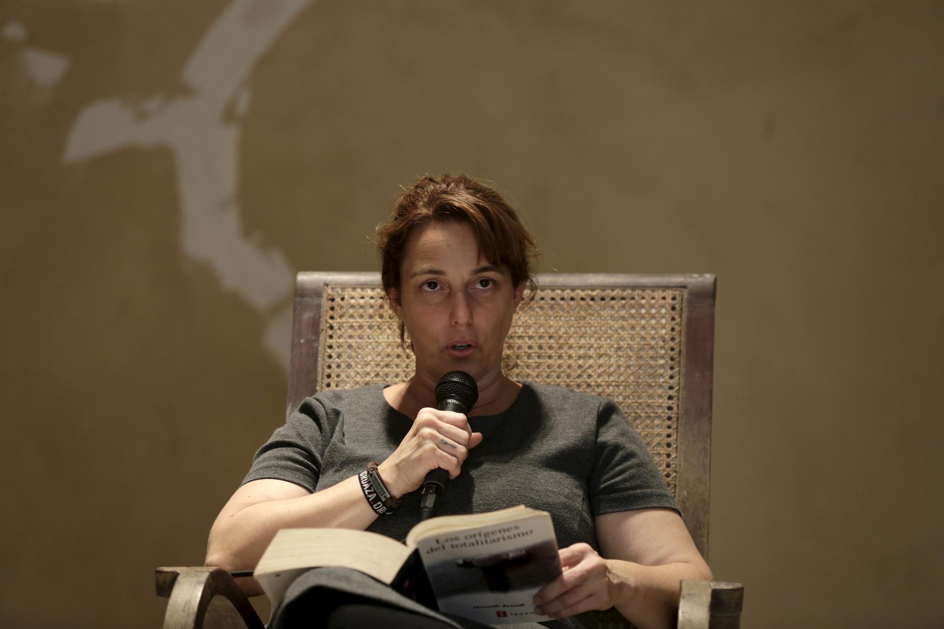 Cuban artist Tania Bruguera reads from Hannah Arendt's book "The Origins of Totalitarianism" as part of a 100-hour collective reading in Havana May 20, 2015.