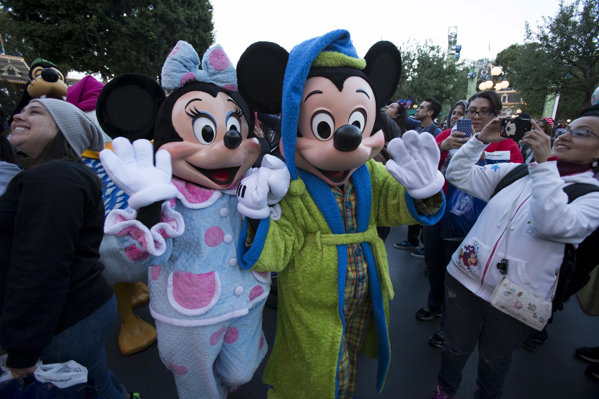 The characters of Mickey Mouse and Minnie Mouse greet guests during Disneyland's Diamond Celebration in Anaheim, California May 23, 2015.
