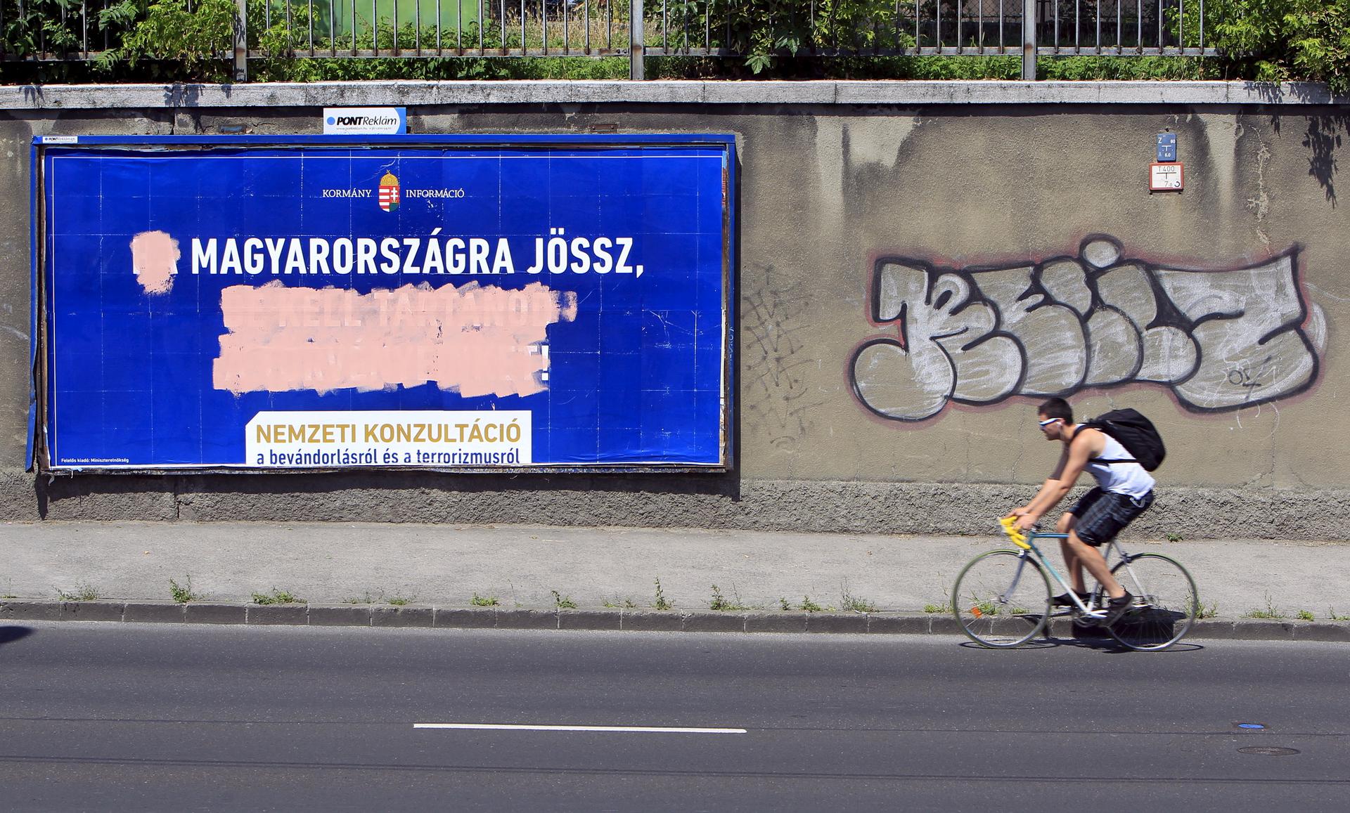 Government billboards vilifying immigrants destroyed by opposition activists are seen in Budapest, Hungary.