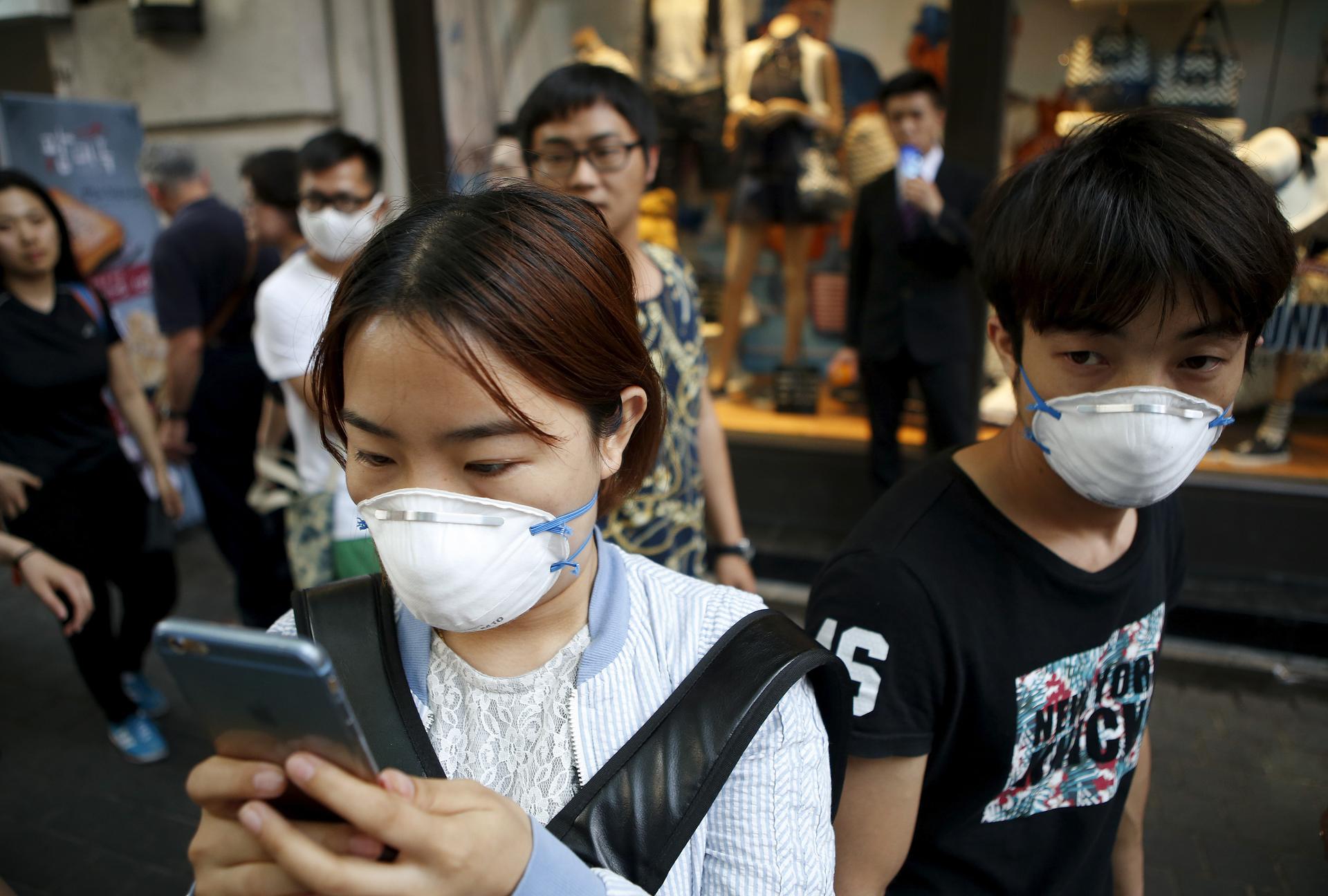 A South Korean woman wears a mask to prevent contracting Middle East Respiratory Syndrome (MERS).   Five new cases were reported by the Health Ministry on Monday, taking the total to 150, the largest outbreak outside of Saudi Arabia. The ministry also sai