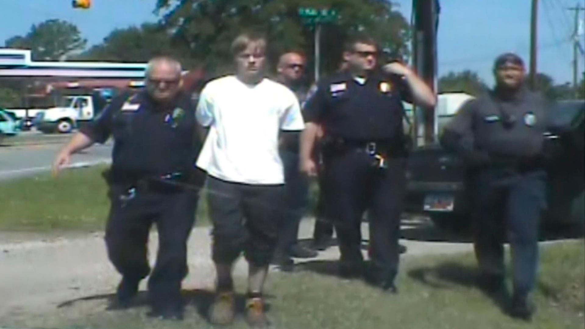 South Carolina shooting suspect Dylann Roof (C) is escorted by police after being detained in Shelby, North Carolina June 18, in this still image from a dash cam video released by the Shelby Police Department June 23, 2015.