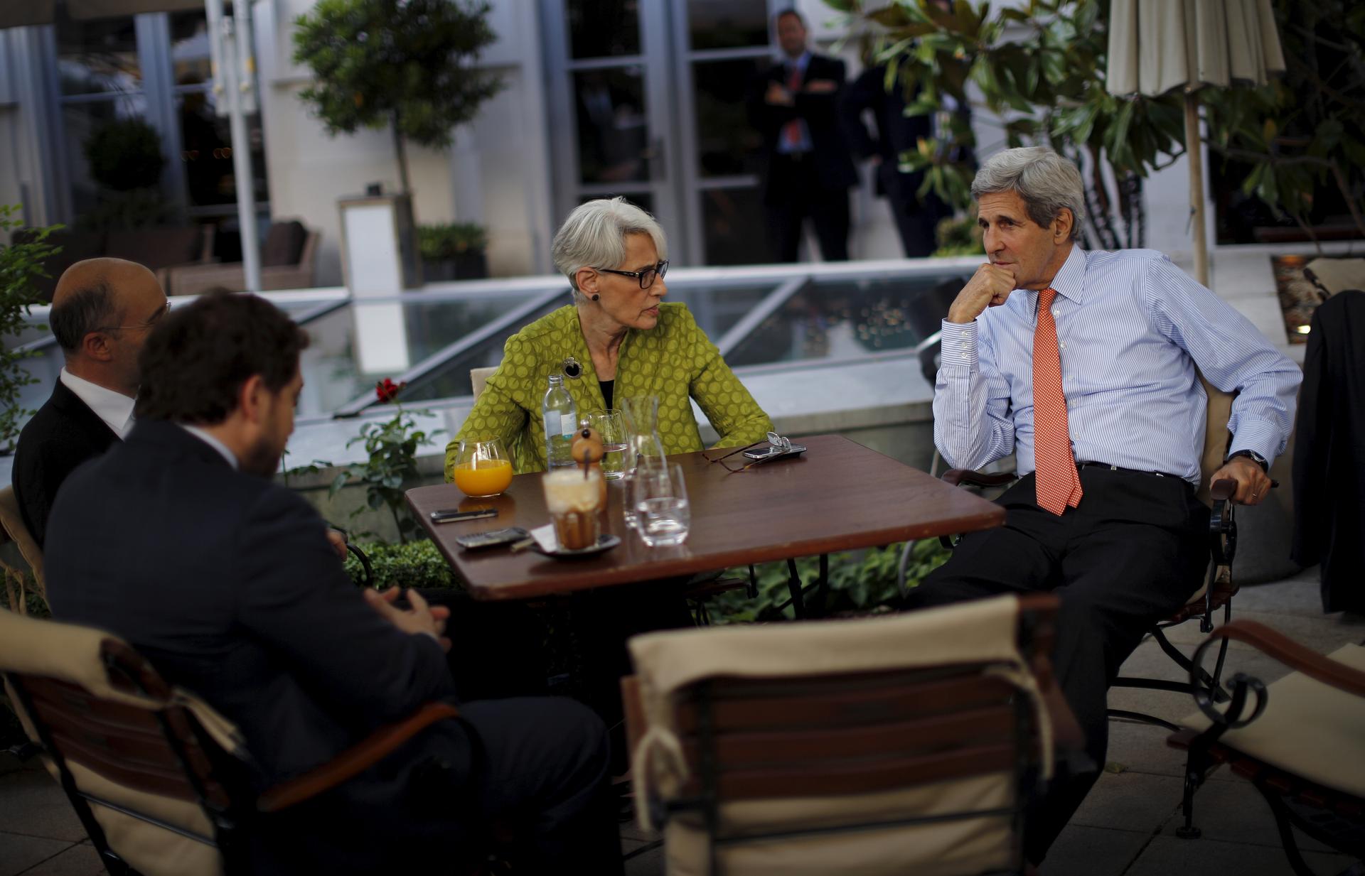 U.S. Secretary of State John Kerry (R), U.S. Under Secretary for Political Affairs Wendy Sherman (C), National Security Council point person on the Middle East Robert Malley (L) and Chief of Staff Jon Finer (2nd L) meet on the terrace of a hotel where the