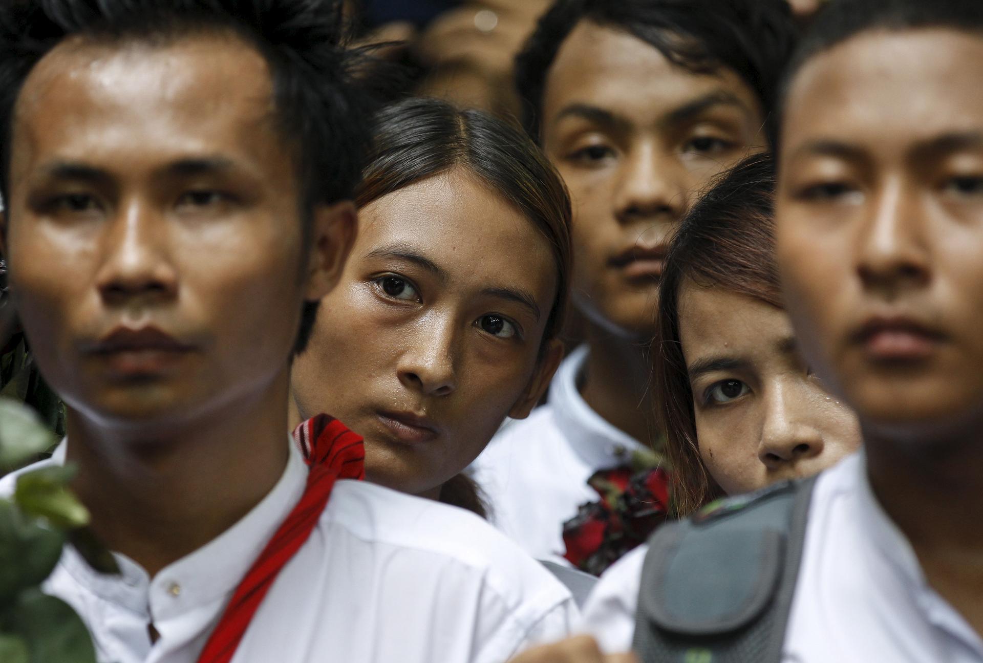 Demonstrators listen as a student leader gives a speech during a protest led by students at Yangon University in Myanmar July 7, 2015