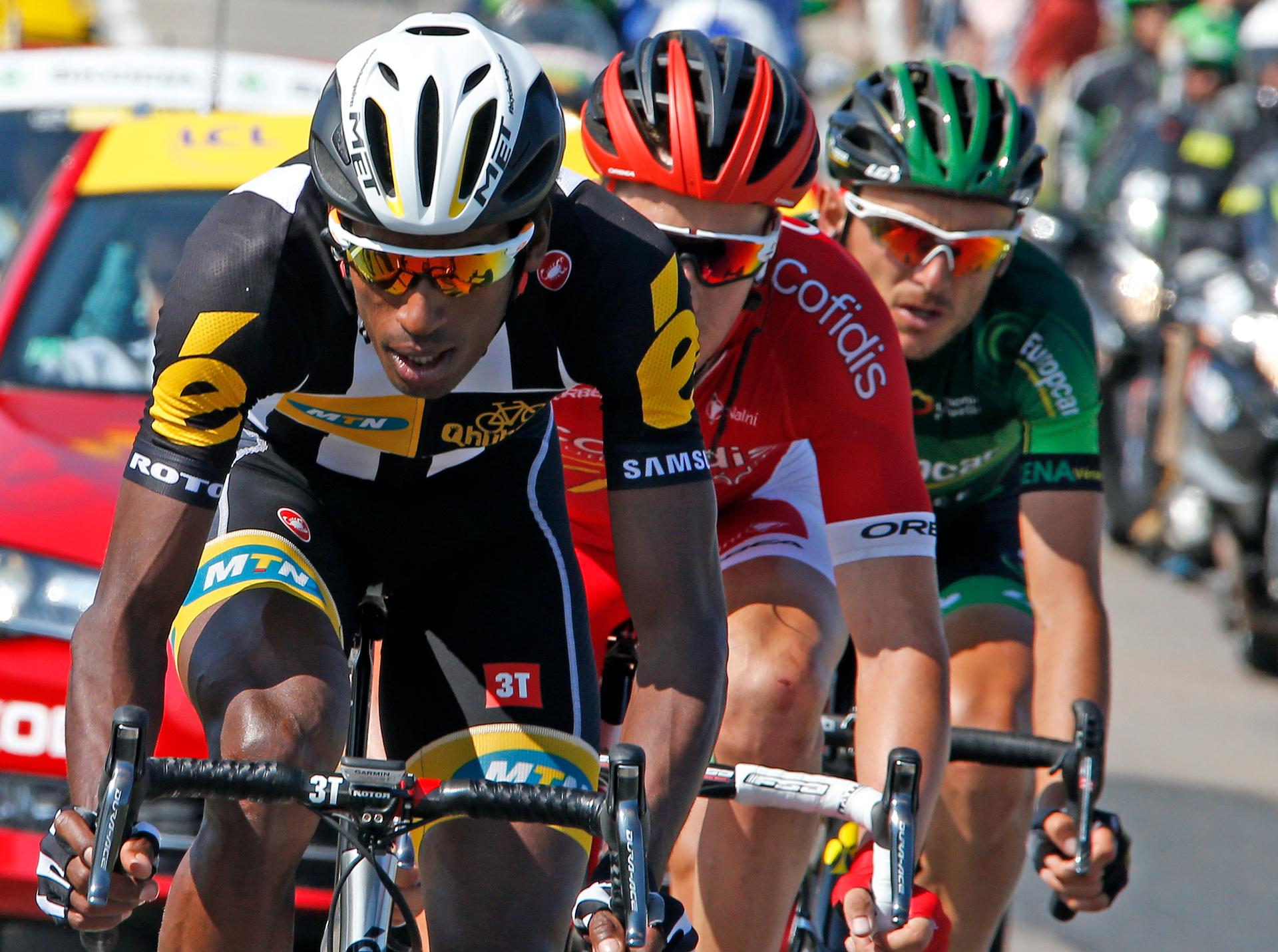 MTN-Qhubeka rider Daniel Teklehaimanot of Eritrea (L) wtih two racers on his tail during a break away in the 6th stage of the Tour de France.