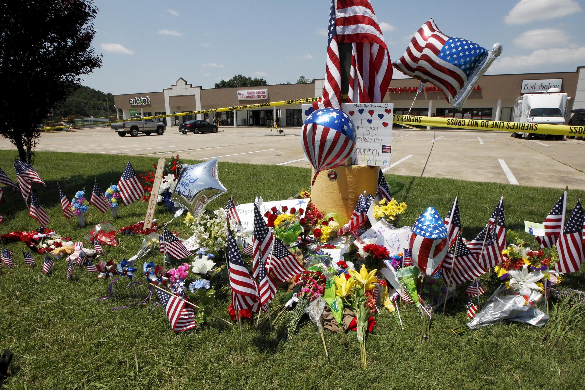 Items left at a memorial at the Armed Forces Career Center are seen in Chattanooga, Tennessee.