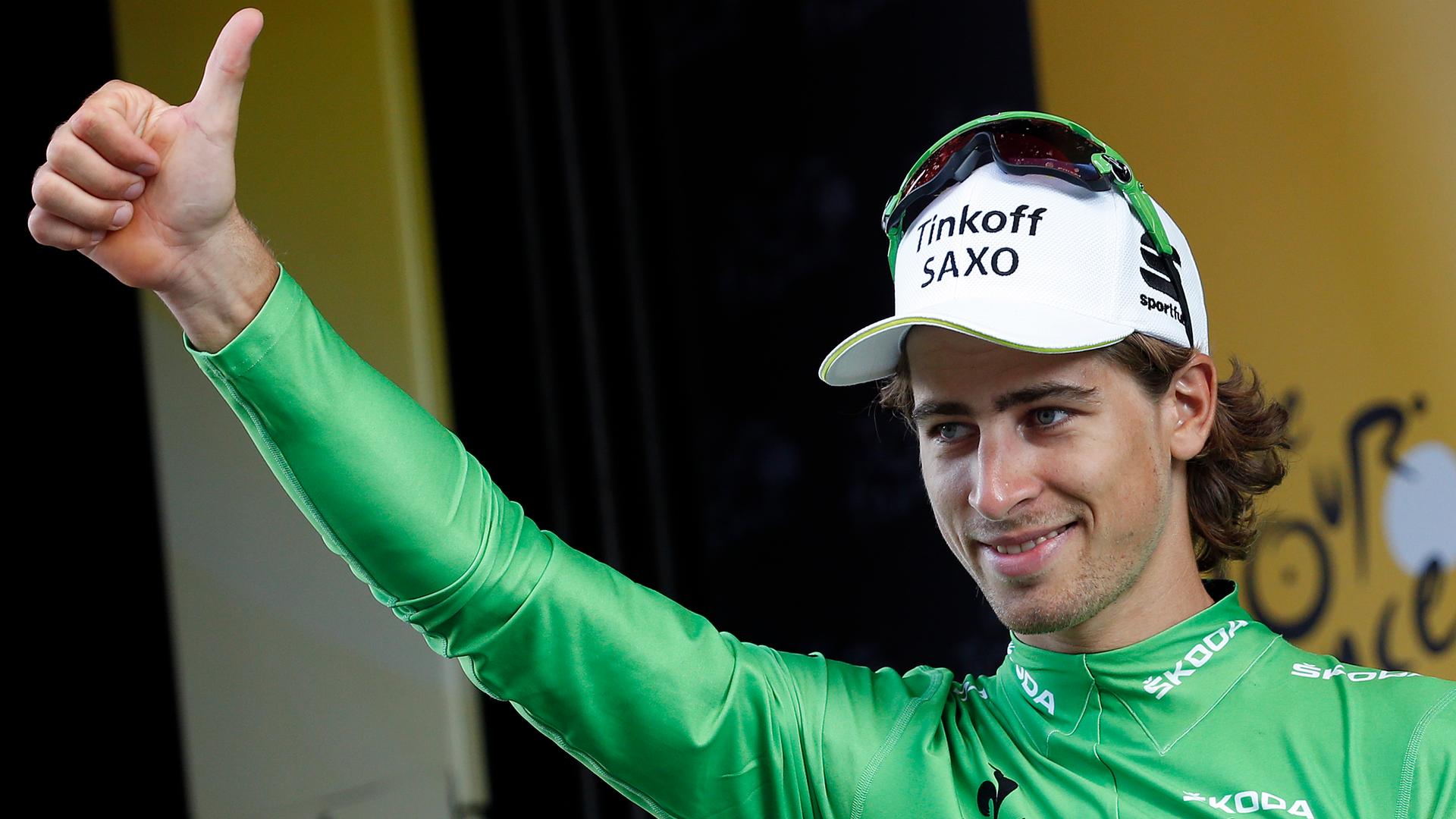 Tinkoff-Saxo rider Peter Sagan of Slovakia gives a thumb up as he wears the green best sprinter jersey on the podium after the 201-km ( 124 miles) 16th stage of the 102nd Tour de France cycling race from Bourg-de-Peage to Gap, France, July 20, 2015.