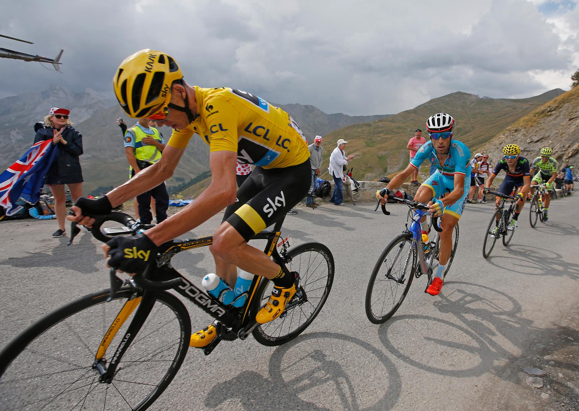 Team Sky rider Chris Froome of Britain (L), race leader's yellow jersey, climbs the Allos pass followed by Astana rider Vincenzo Nibali of Italy during the 161-km (100 miles) 17th stage of the 102nd Tour de France cycling race from Digne-les-Bains to Pra 