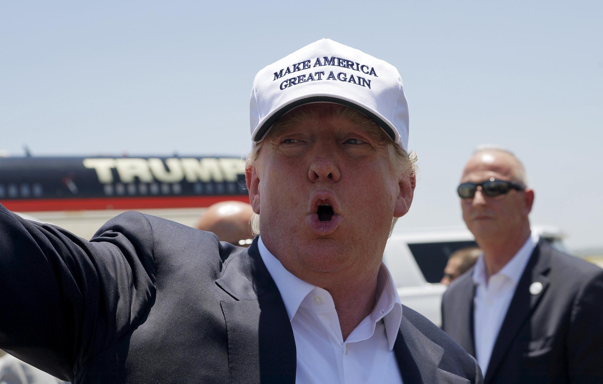 Republican presidential candidate Donald Trump talks to reporters as he arrives in Laredo, Texas July 23, 2015. 