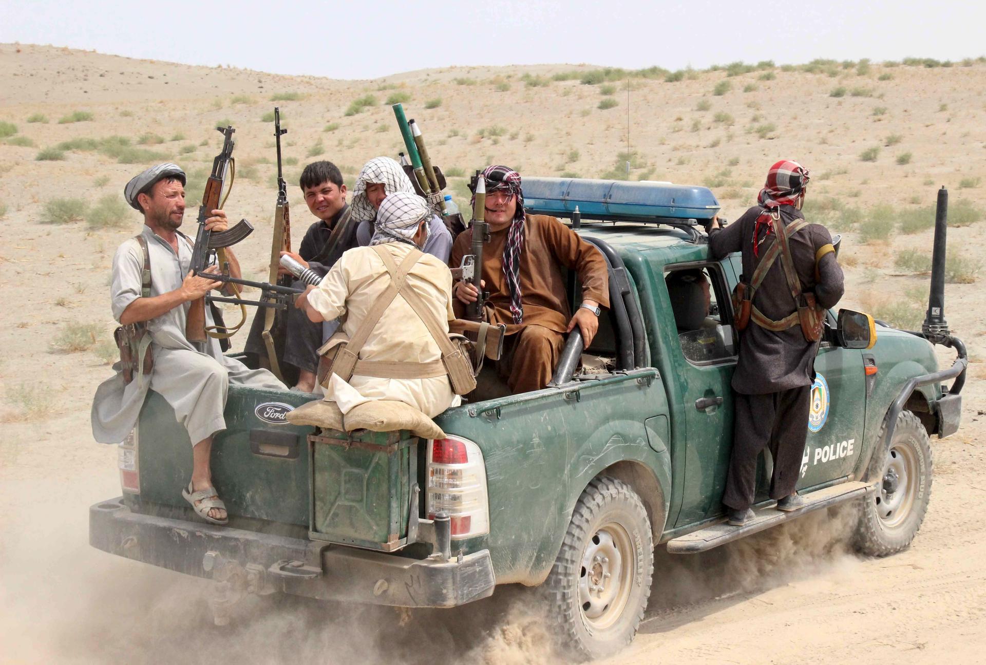 Afghan local police sit at the back of a truck near a frontline during a battle with the Taliban at Qalay- i-zal district, in Kunduz province, Afghanistan August 1, 2015.