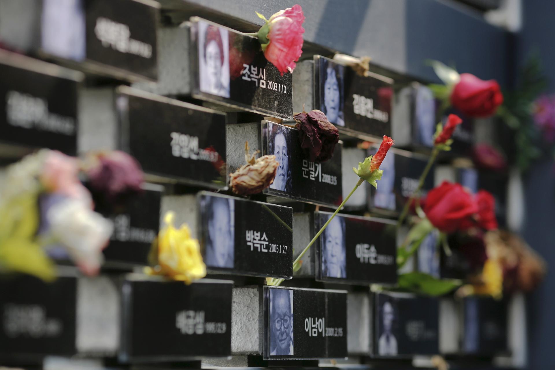 Flowers are placed on a memorial wall commemorating the late former South and North Korean "comfort women" at the War and Women's Human Rights Museum" in Seoul, South Korea, July 22, 2015. â€œComfort womenâ€? is the Japanese euphemism for women who were f