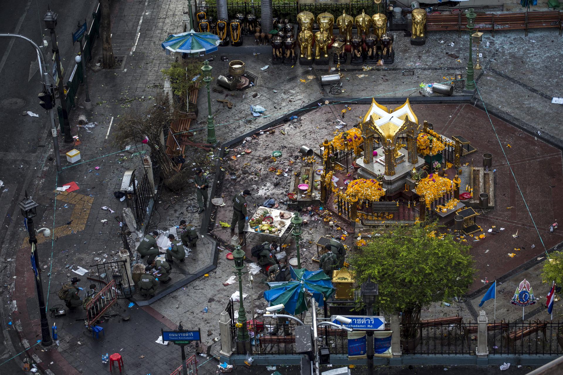 Experts investigate the Erawan shrine at the site of a deadly blast in central Bangkok, Thailand.