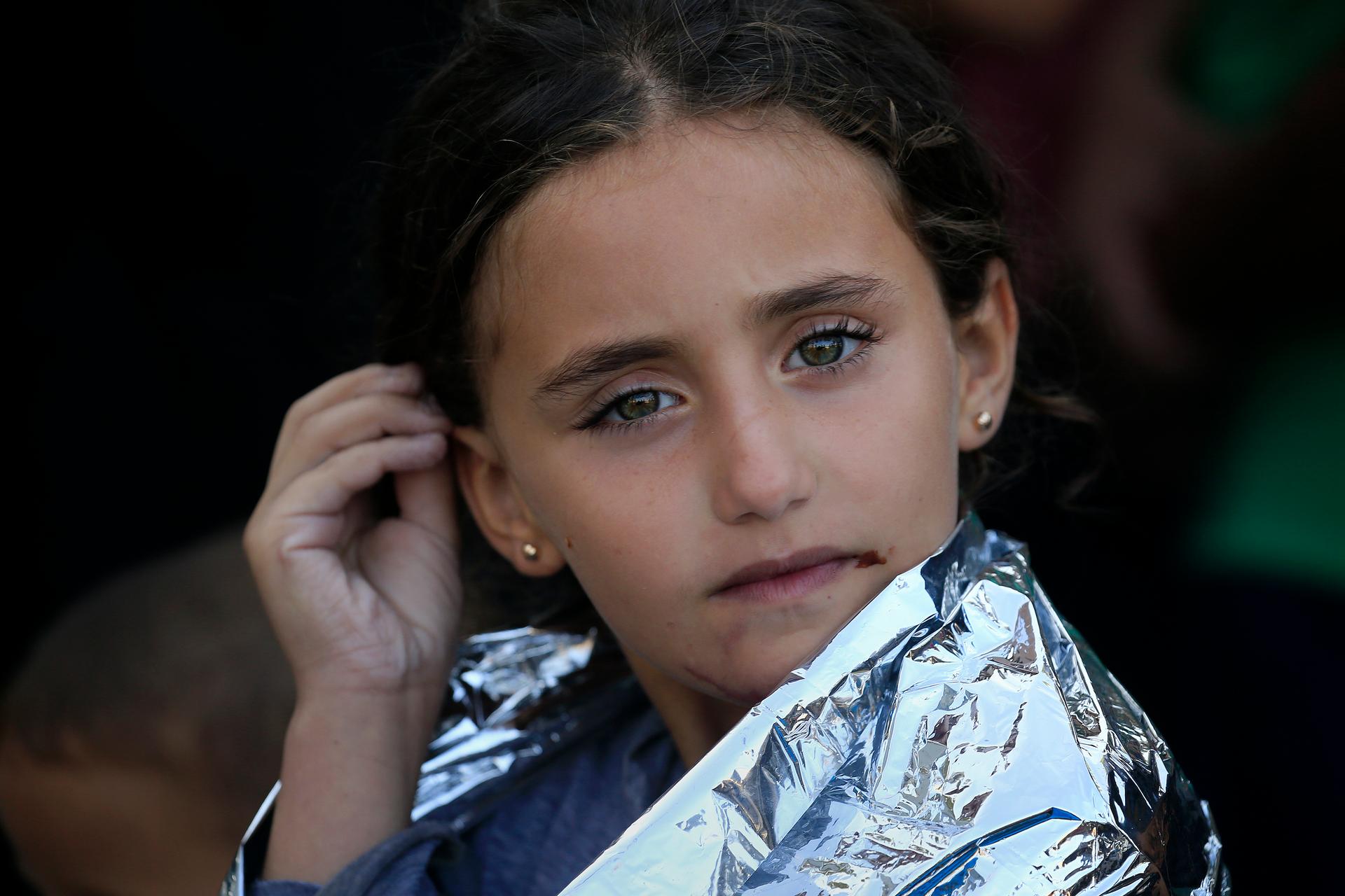 A young Syrian girl is wrapped with a thermal blanket following a rescue operation on the island of Lesbos, in Greece. 
