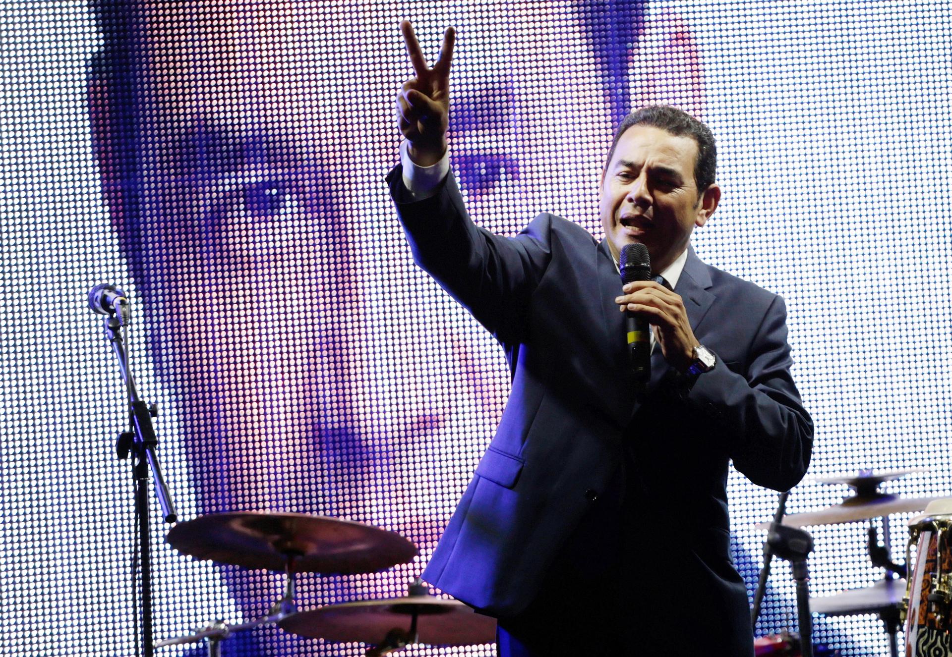 Guatemalan presidential candidate for National Convergence Front, Jimmy Morales, flashes the victory sign as he addresses supporters outside his campaign headquarters in Guatemala City, September 6, 2015.