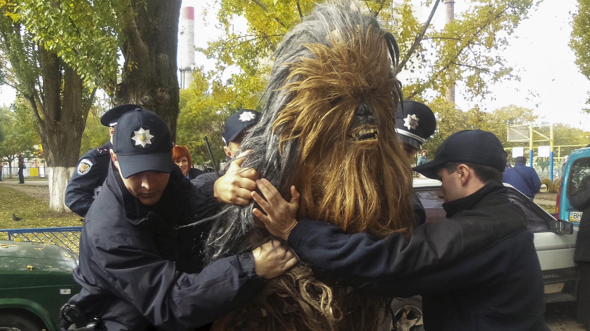 Policemen detain a person dressed as Star Wars character Chewbacca during a regional election near a polling station in Odessa, Ukraine, October 25, 2015.