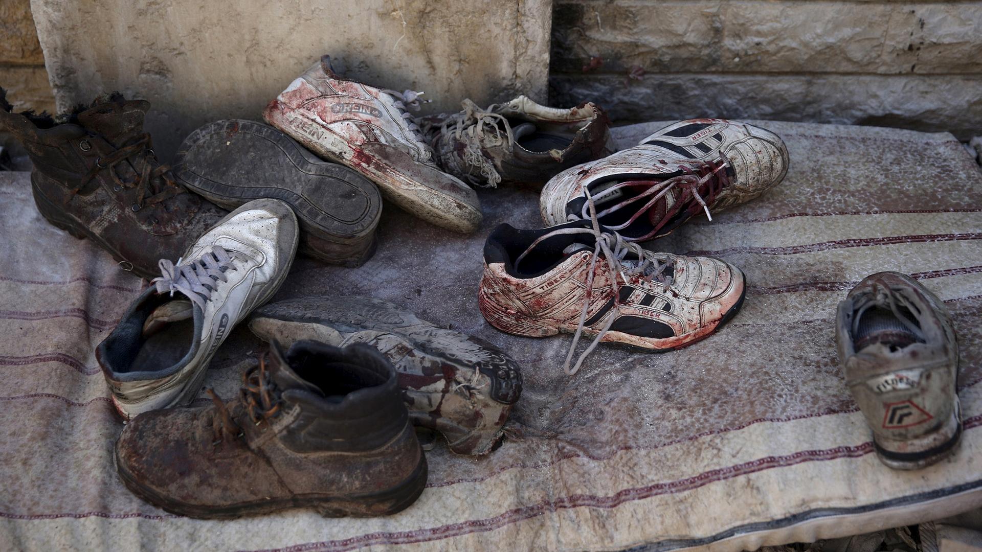 Bloodstained shoes are pictured after Syrian government forces fired missiles on a busy marketplace in Douma, a suburb of Damascus, October 30, 2015.