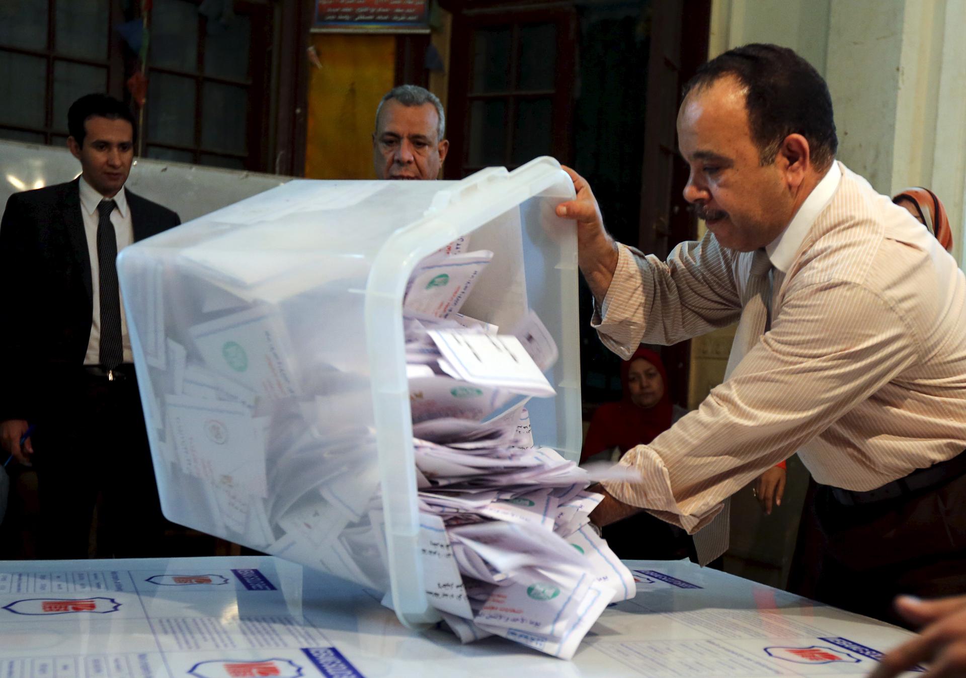 Officials count ballots after polls closed during the second round of parliamentary election in Cairo, Egypt, on Nov. 23, 2015.
