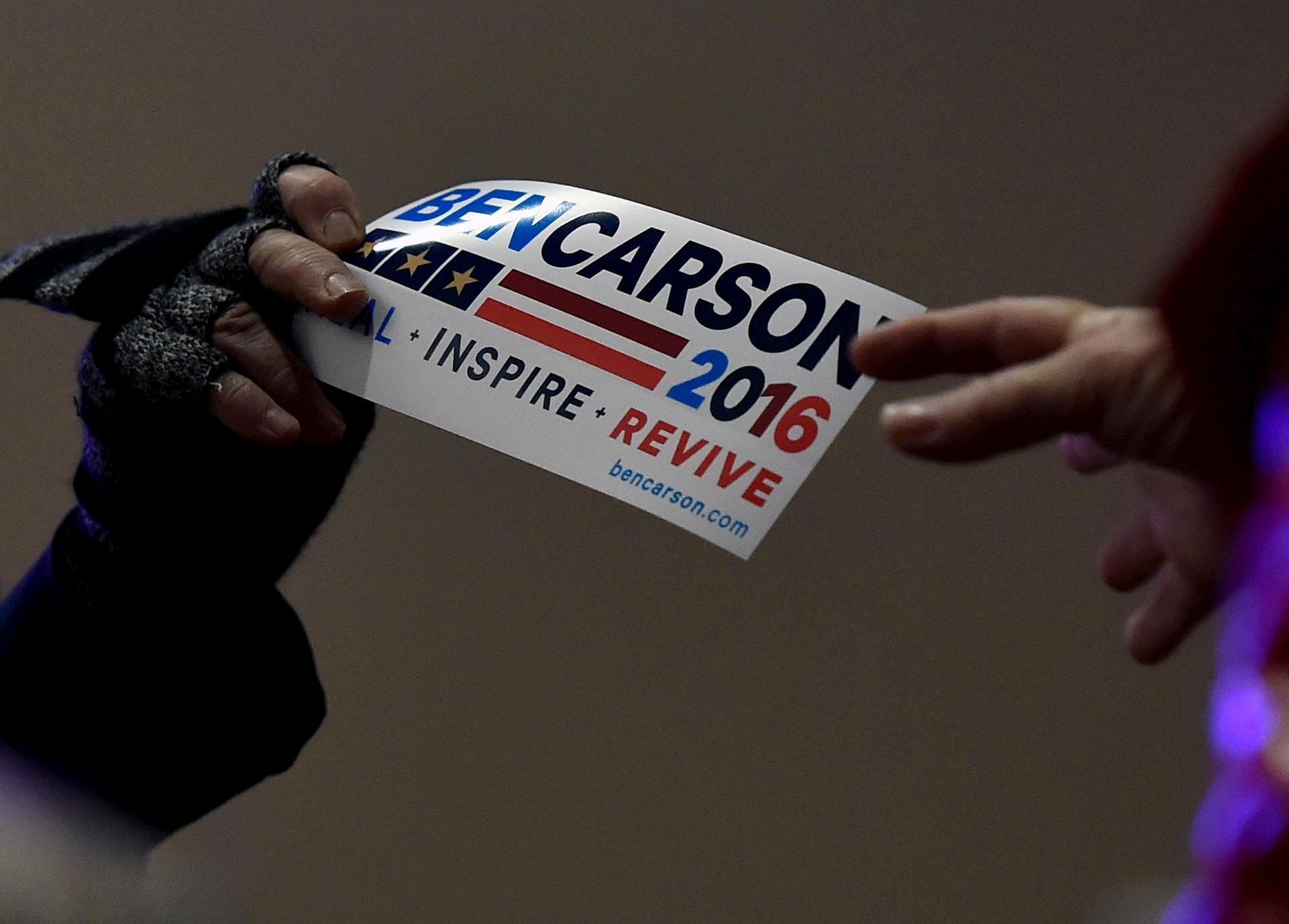 A bumper sticker is passed out before U.S. Republican presidential candidate Ben Carson speaks at a campaign event in Pahrump, Nevada.
