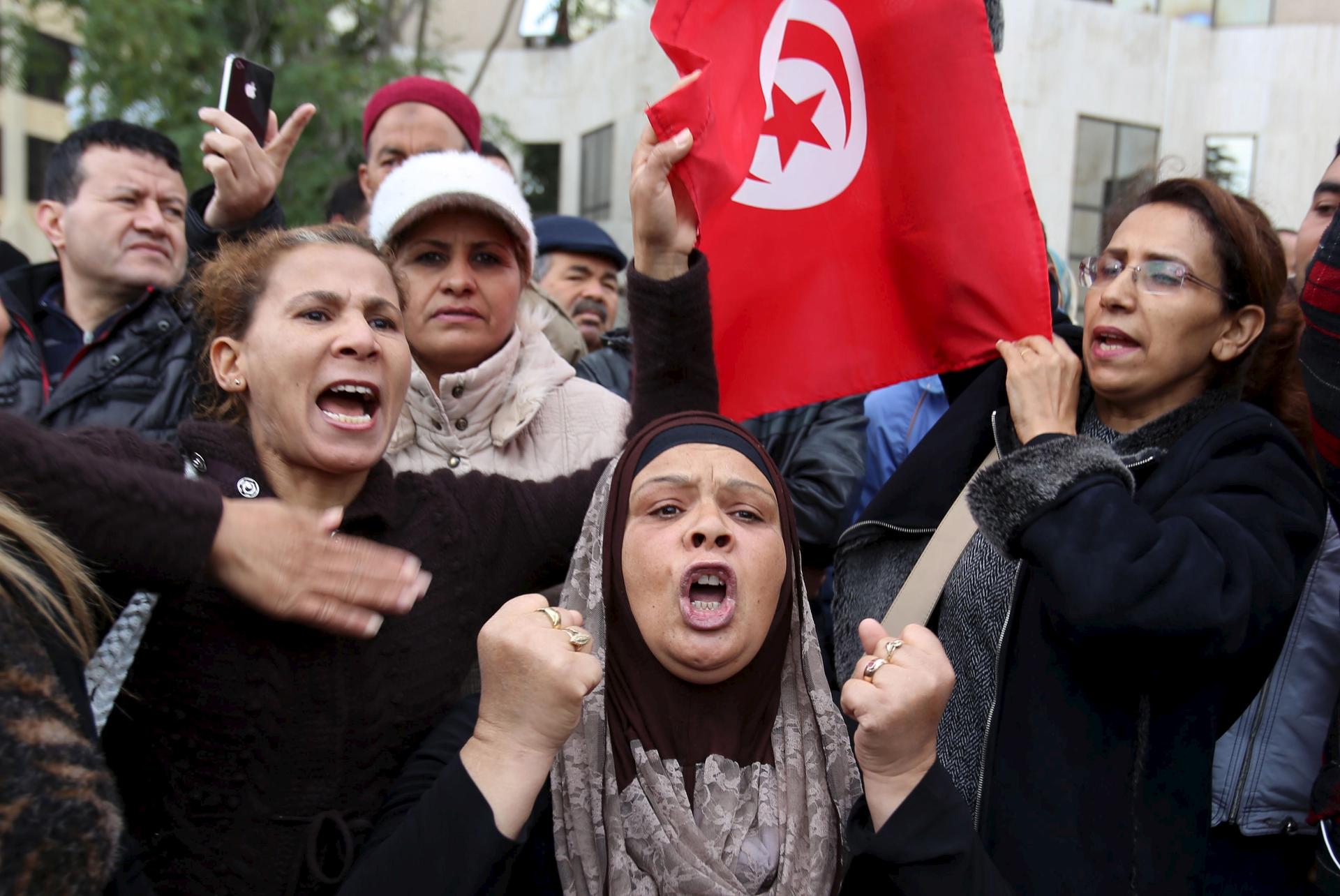 People shout slogans at a protest to condemn a suicide bomb attack in Tunis, Tunisia November 25, 2015.
