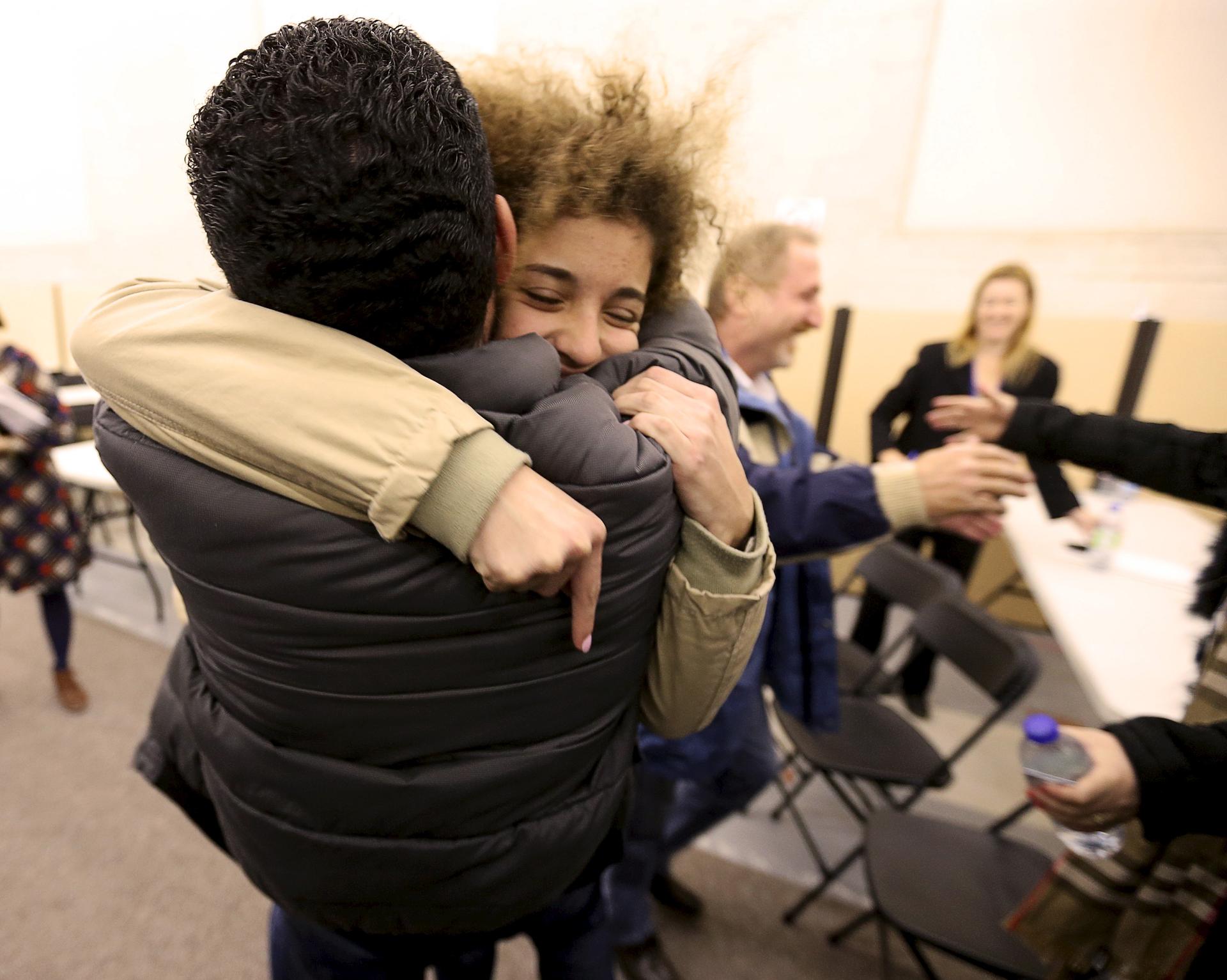 Anas Francis is reunited with his cousin Syrian refugee Laila Beylouneh, 13, at the Welcome Centre in Montreal, Quebec, December 12, 2015.