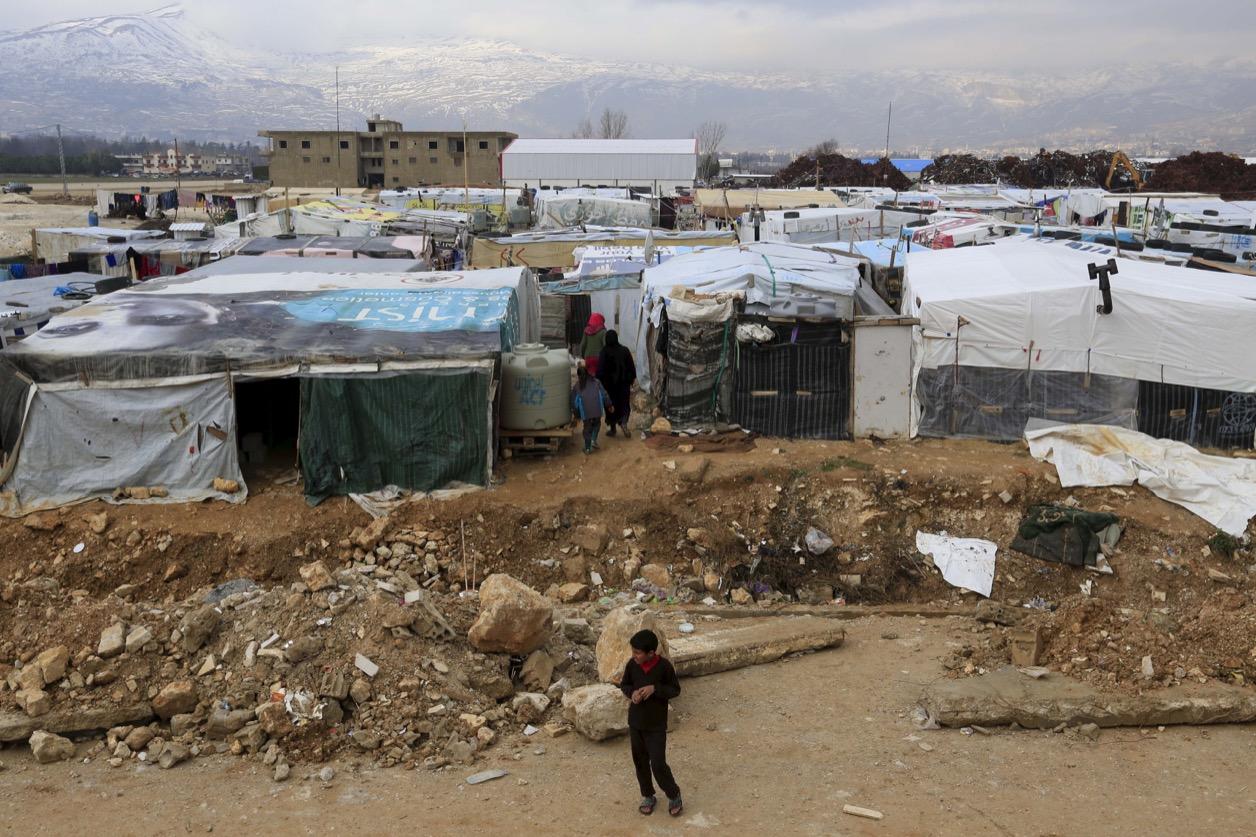 A boy stands near tents inside an informal settlement for Syrian refugees in Taanayel, Bekaa valley, Lebanon in January.