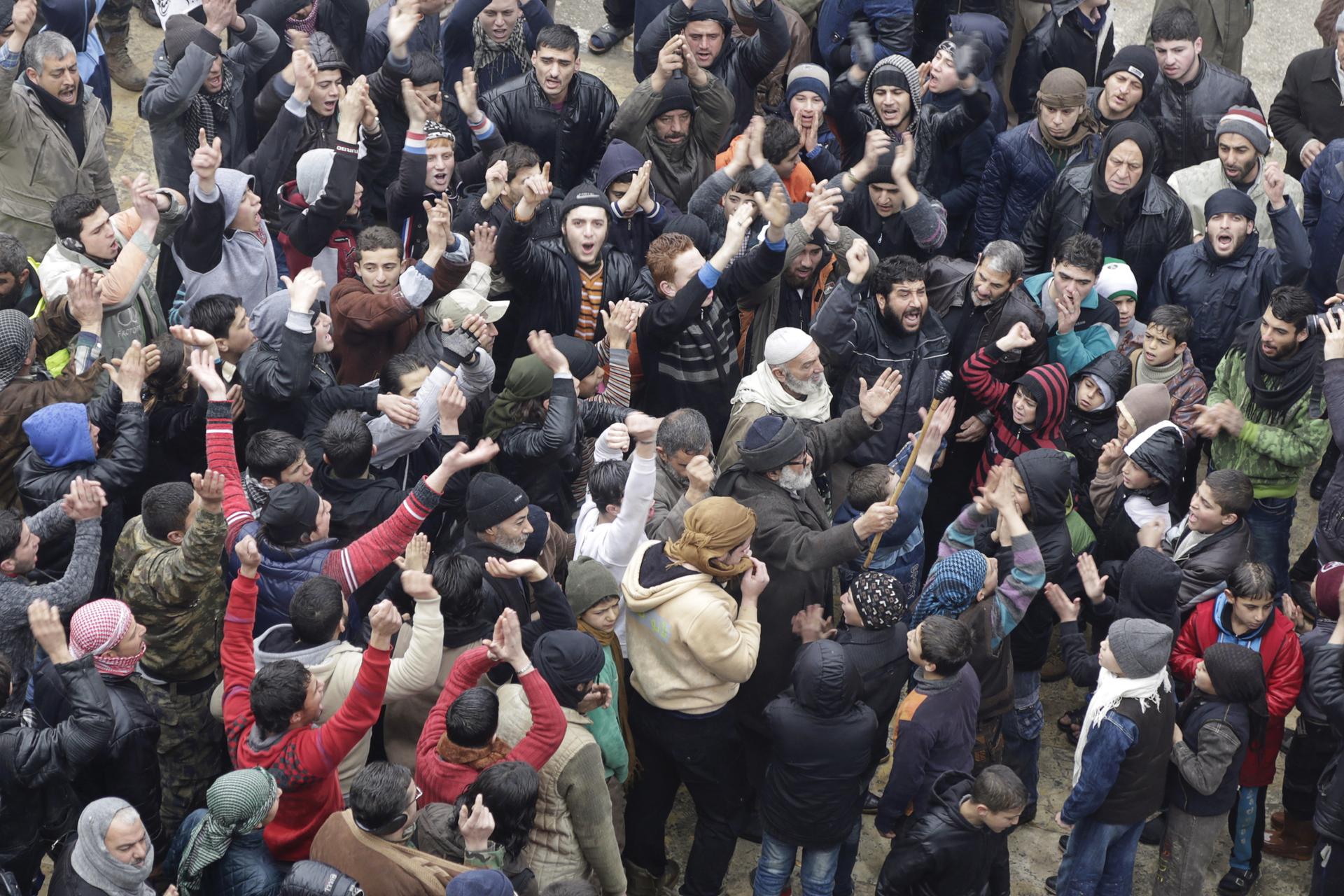 People shout slogans during a protest after Friday prayers, calling for the lifting of the siege off Madaya, in the rebel-controlled area of Maaret al-Numan town in Idlib province, Syria January 8, 2016.
