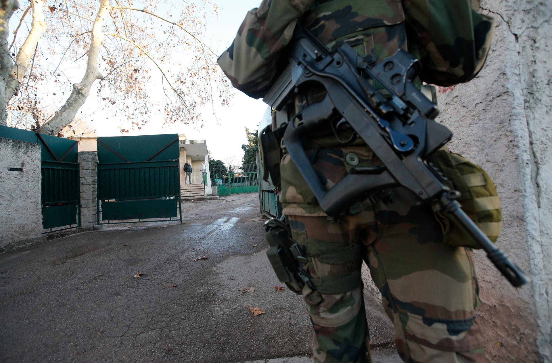 A French soldier secures access to a Jewish school in Marseille, France, January 11, 2016 after a teenager, armed with a machete, slightly wounded a Jewish teacher before being arrested. Armed guards are the new normal for Jewish institutions in France.