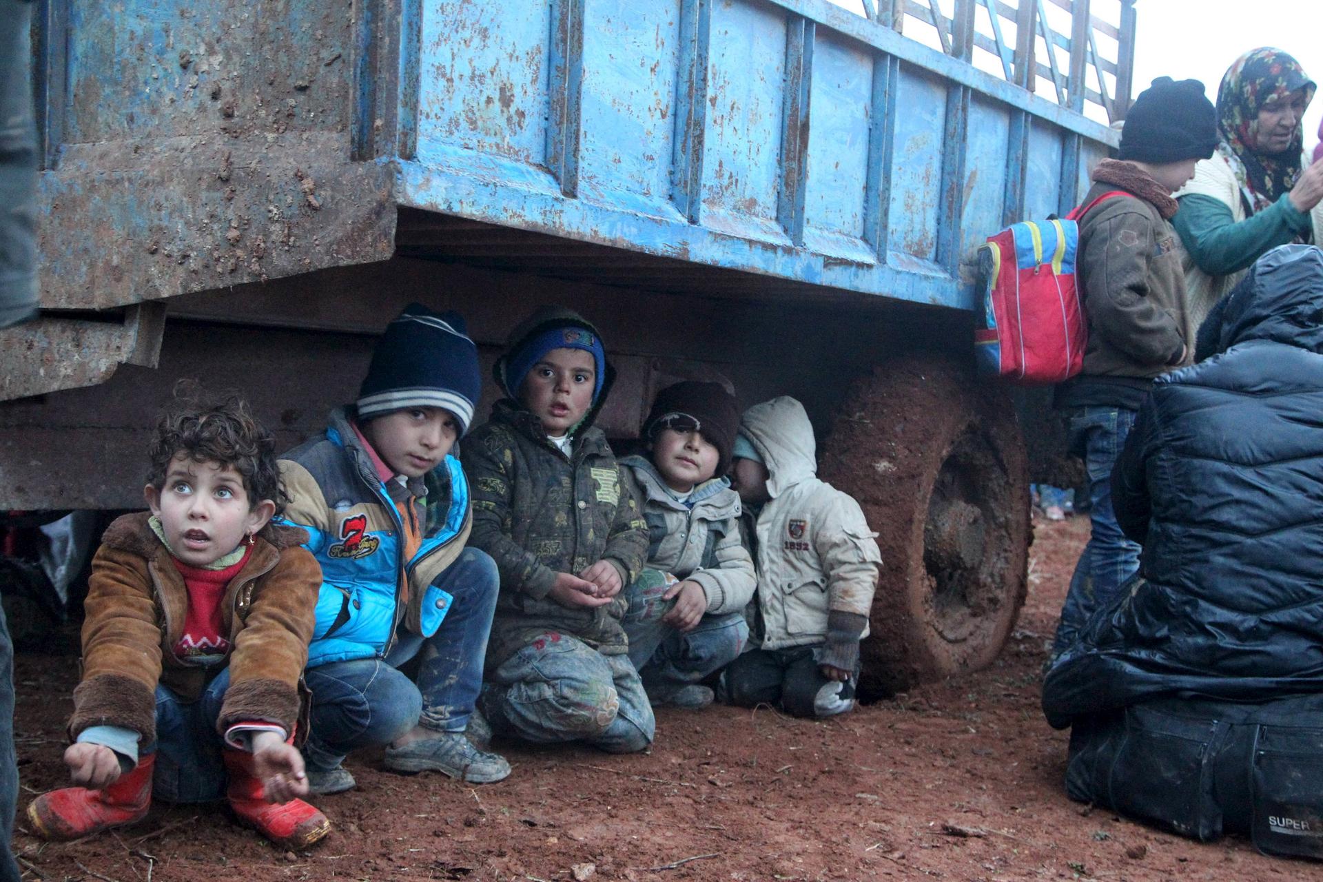 Displaced Syrian children waiting to cross the border into Turkey