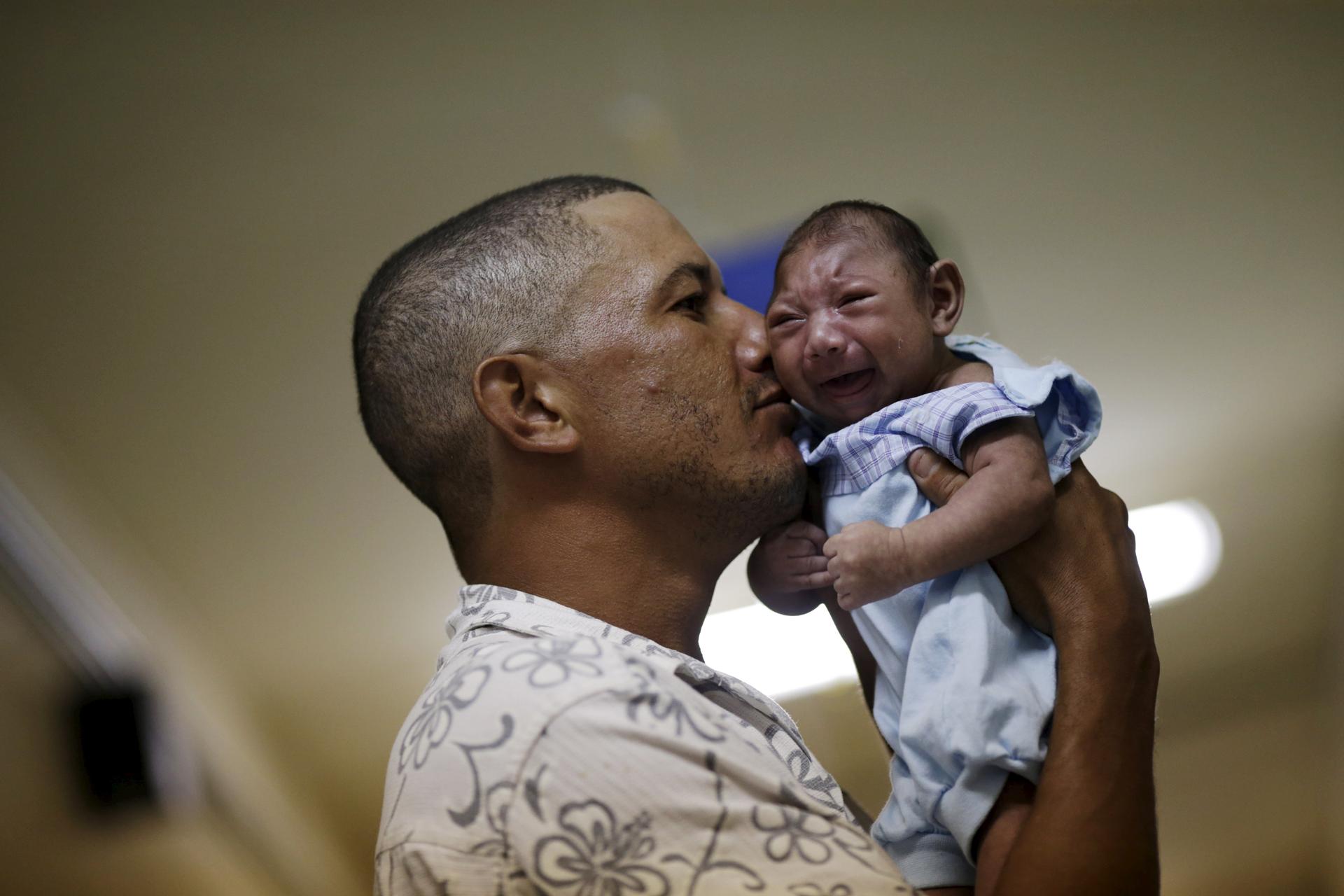 Geovane Silva holds his son Gustavo Henrique, who has microcephaly, in Recife, Brazil. Health authorities in the Brazilian state at the center of a rapidly spreading Zika outbreak have been overwhelmed by the alarming surge in cases of babies born with mi