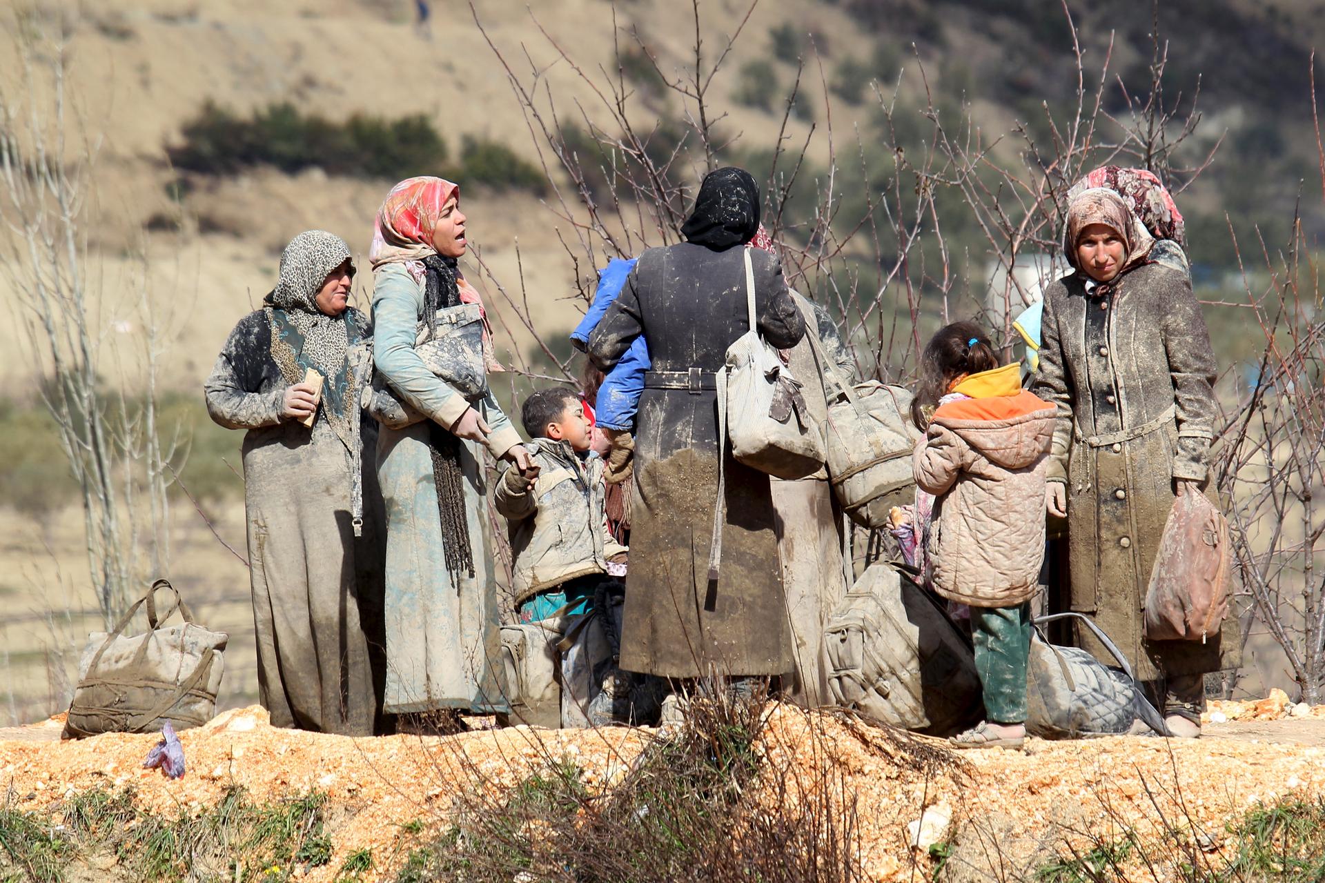Internally displaced people, wait as they are stuck in the town of Khirbet Al-Joz, in Latakia countryside, waiting to get permission to cross into Turkey near the Syrian-Turkish border, Syria, February 7, 2016.