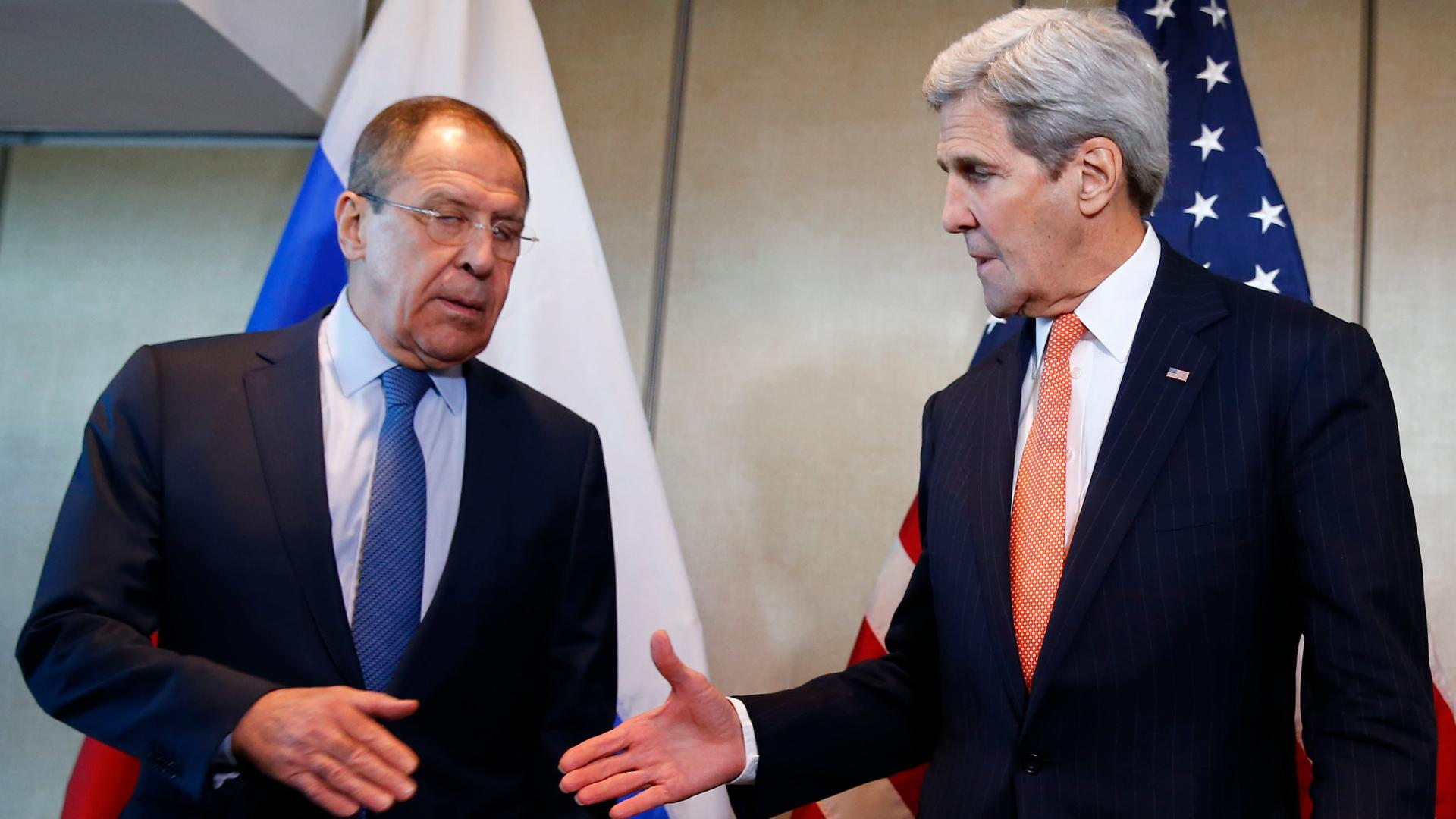 A hesitant deal in Munich. Secretary of State John Kerry prepares to shake hands with his Russian counterpart, Sergei Lavrov.