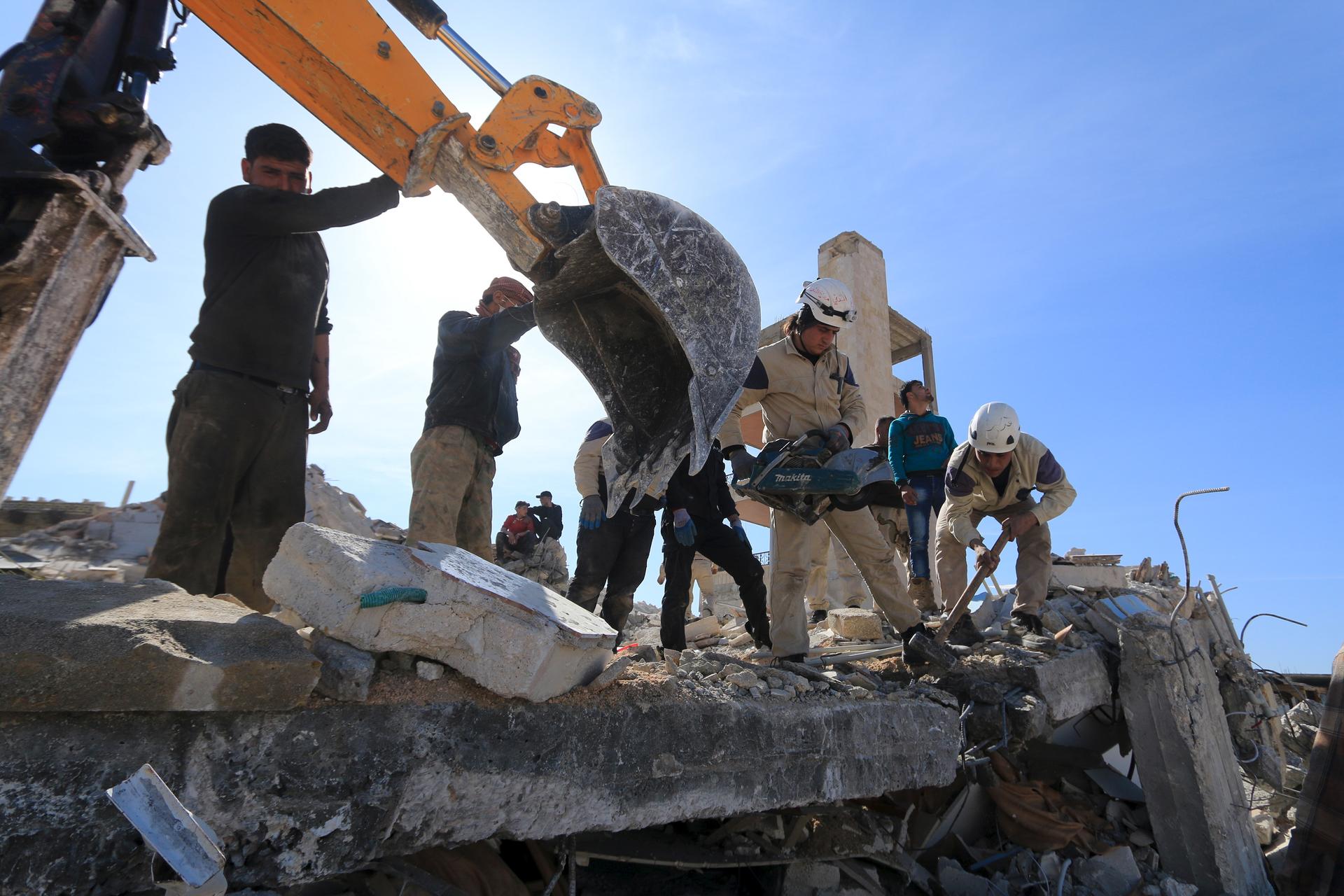 People and Civil Defense members remove rubble while looking for survivors in the ruins of a destroyed Medecins Sans Frontieres (MSF) supported hospital hit by missiles in Marat Numan, Idlib province, Syria, February 16, 2016. 
