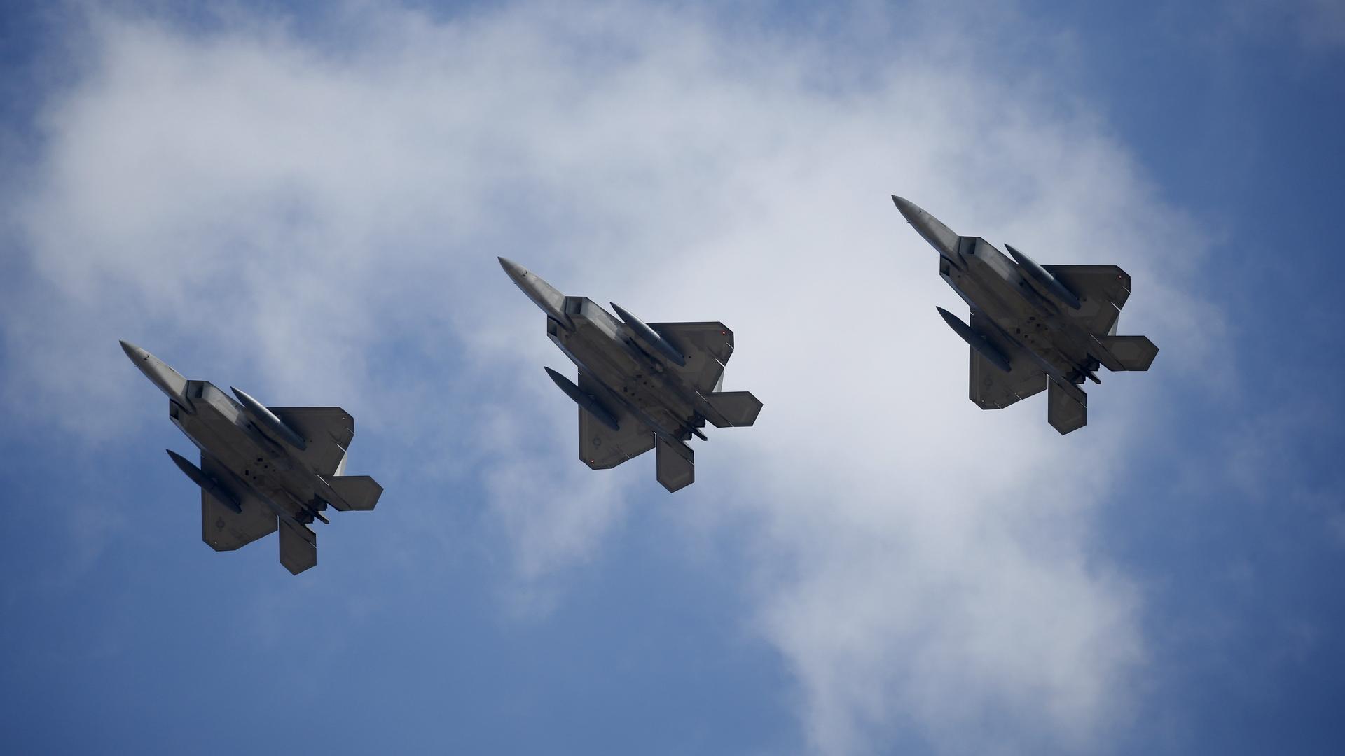 US F-22 stealth fighter jets fly over Osan Air Base in Pyeongtaek, South Korea, Feb. 17, 2016.