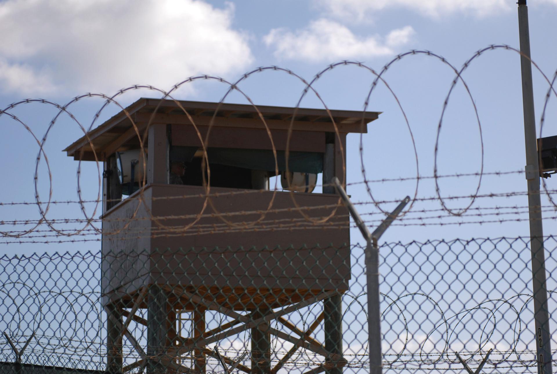 A soldier stands guard in a tower overlooking Camp Delta at Guantanamo Bay naval base in a December 31, 2009 file photo provided by the US Navy.
