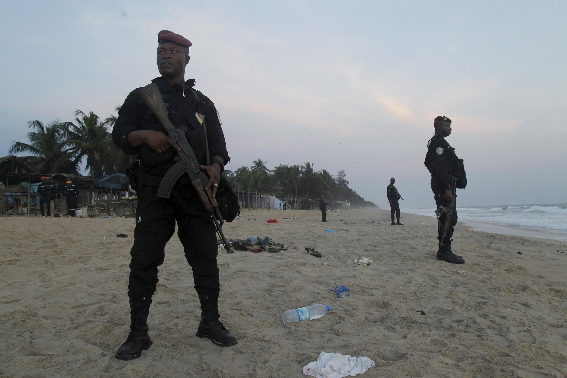 Soldiers stand guard after the beach attack at Grand Bassam in Ivory Coast