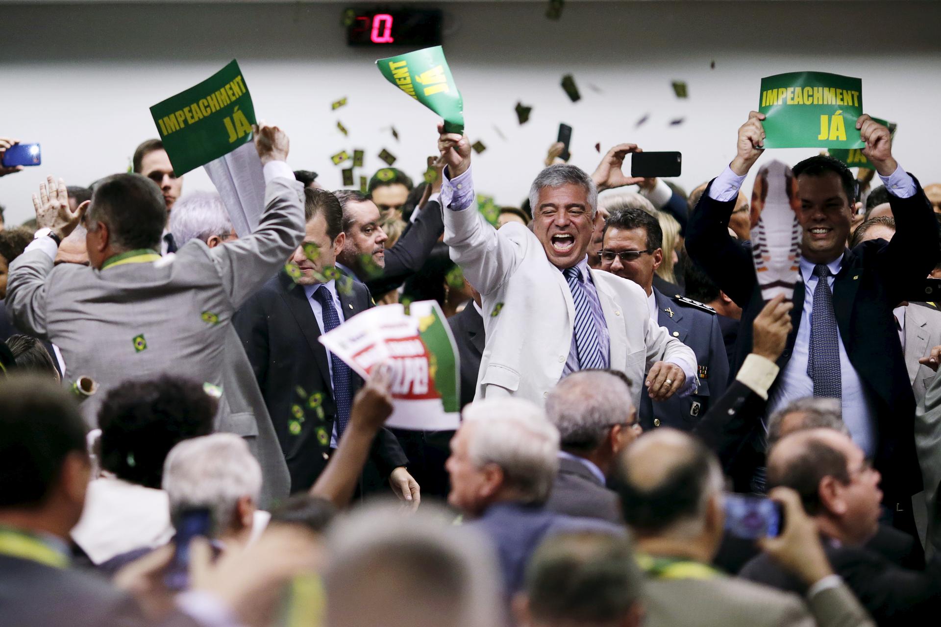 Congressional committee members celebrate after voting to go ahead with impeachment proceedings against Brazilian President Dilma Rousseff at the National Congress in Brasilia on April 11.