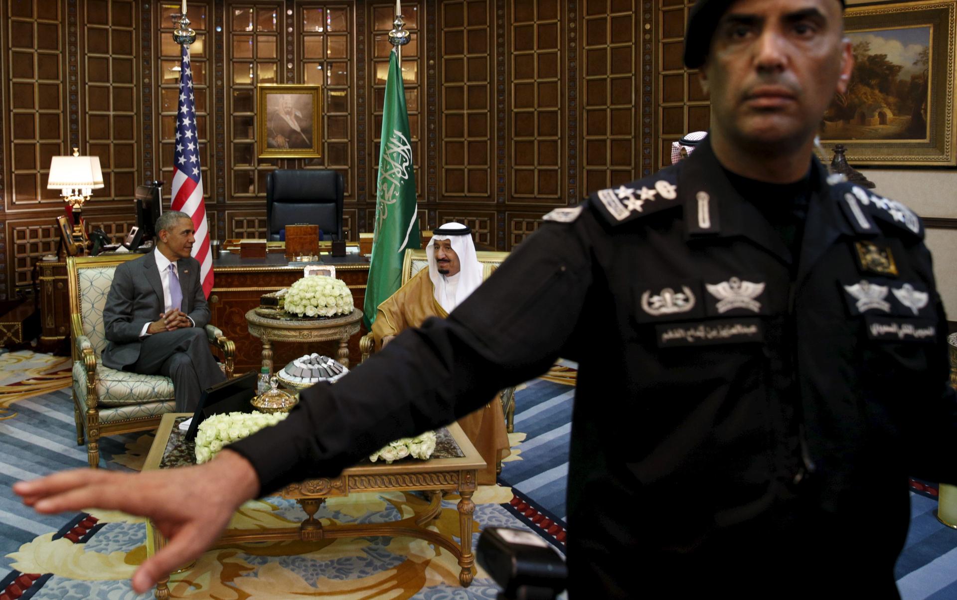 A guard ushers away photographers as President Barack Obama meets with Saudi King Salman in Riyadh, Saudi Arabia April 20, 2016