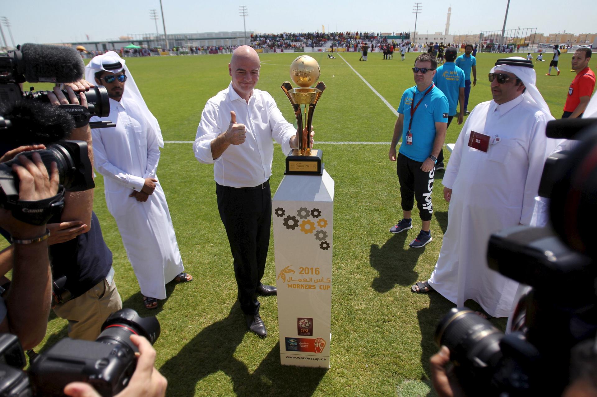 FIFA's newly elected president Gianni Infantino poses with the Qatar Workers Cup trophy in Doha, Qatar, April 22, 2016.