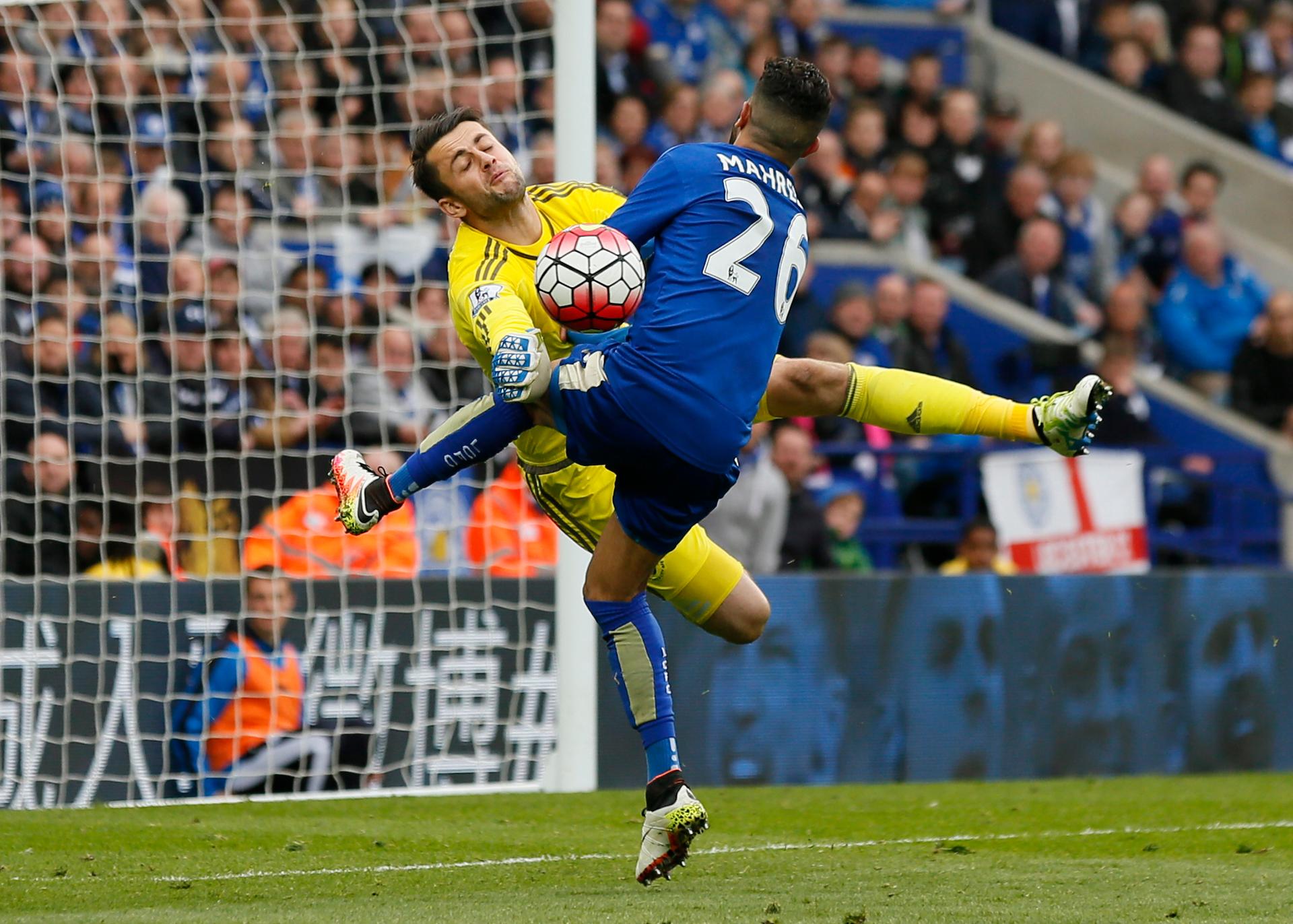 Leicester City's Riyad Mahrez crashes into Swansea's Lukasz Fabianski on the pitch.