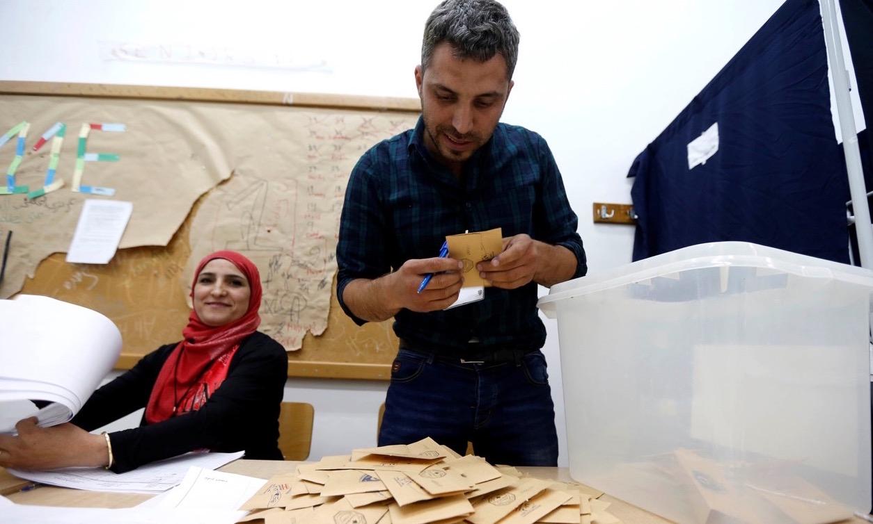 A Lebanese election official counts ballots during Beirut's municipal elections on May 8, 2016.