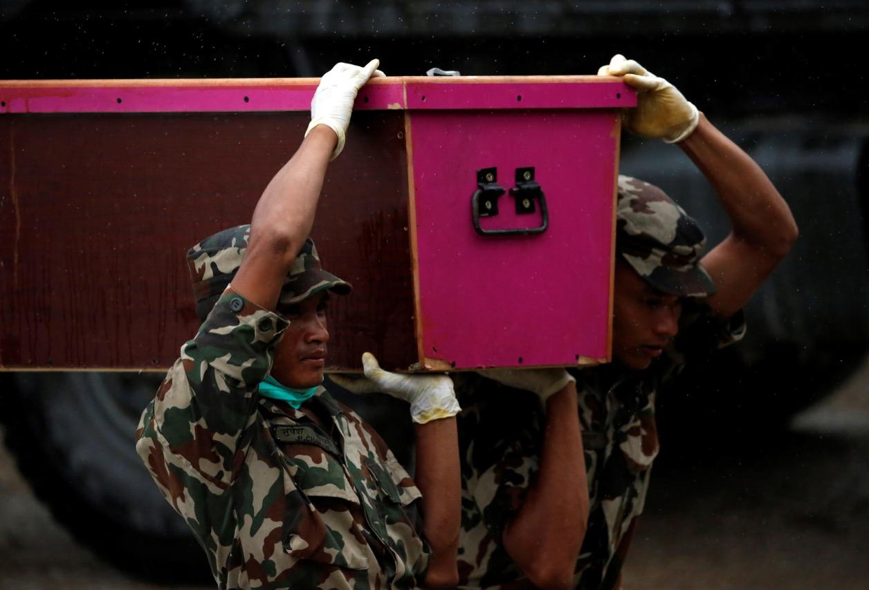 Soldiers at Tribhuvan International Airport in Kathmandu, Nepal on June 22 carry a coffin containing the body of a fellow Nepali man killed when a bomber struck a minibus in Kabul.