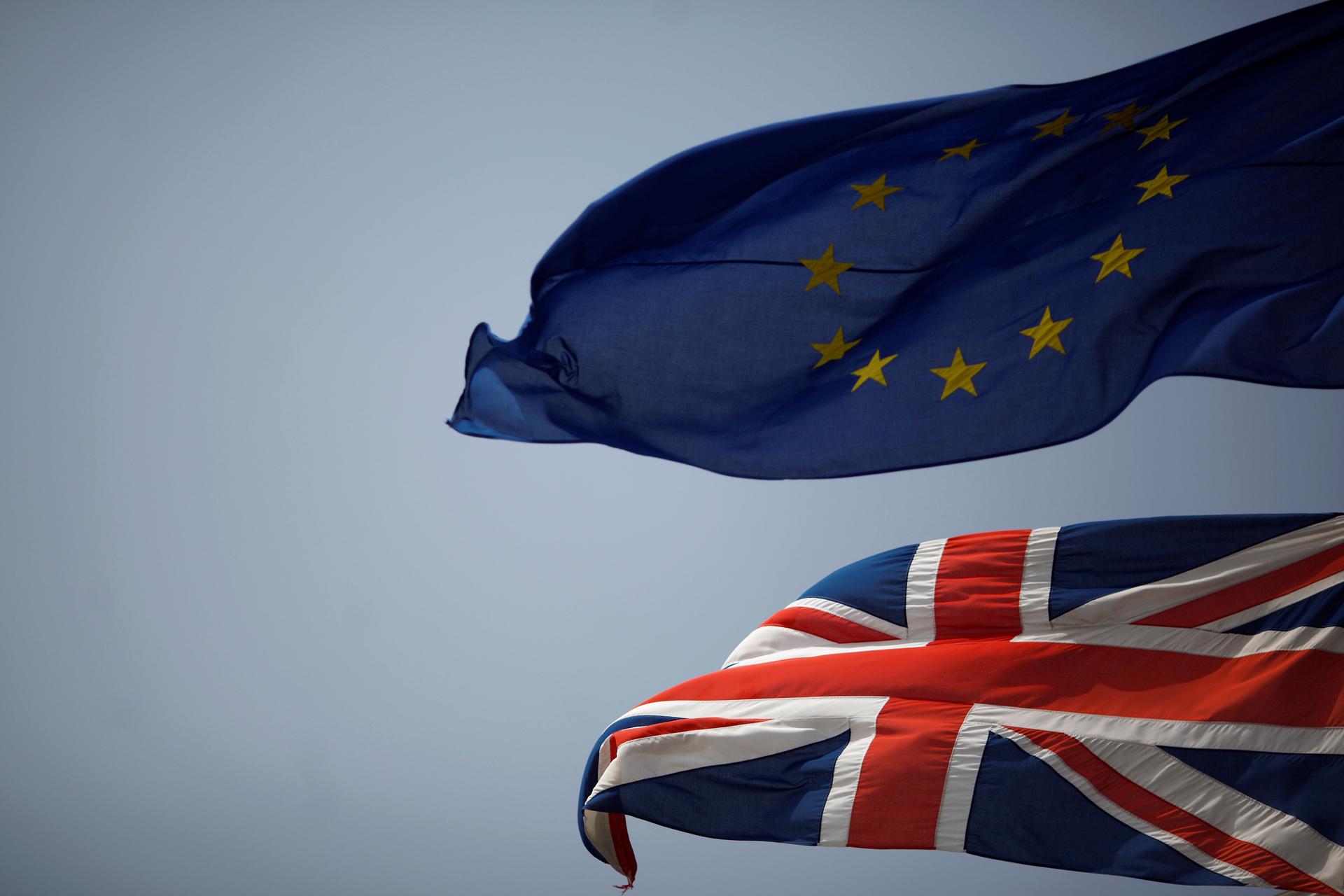 The Union Jack (bottom) and the European Union flag are seen flying, June 27, 2016, after Britain voted to leave the European Union in the EU Brexit referendum.