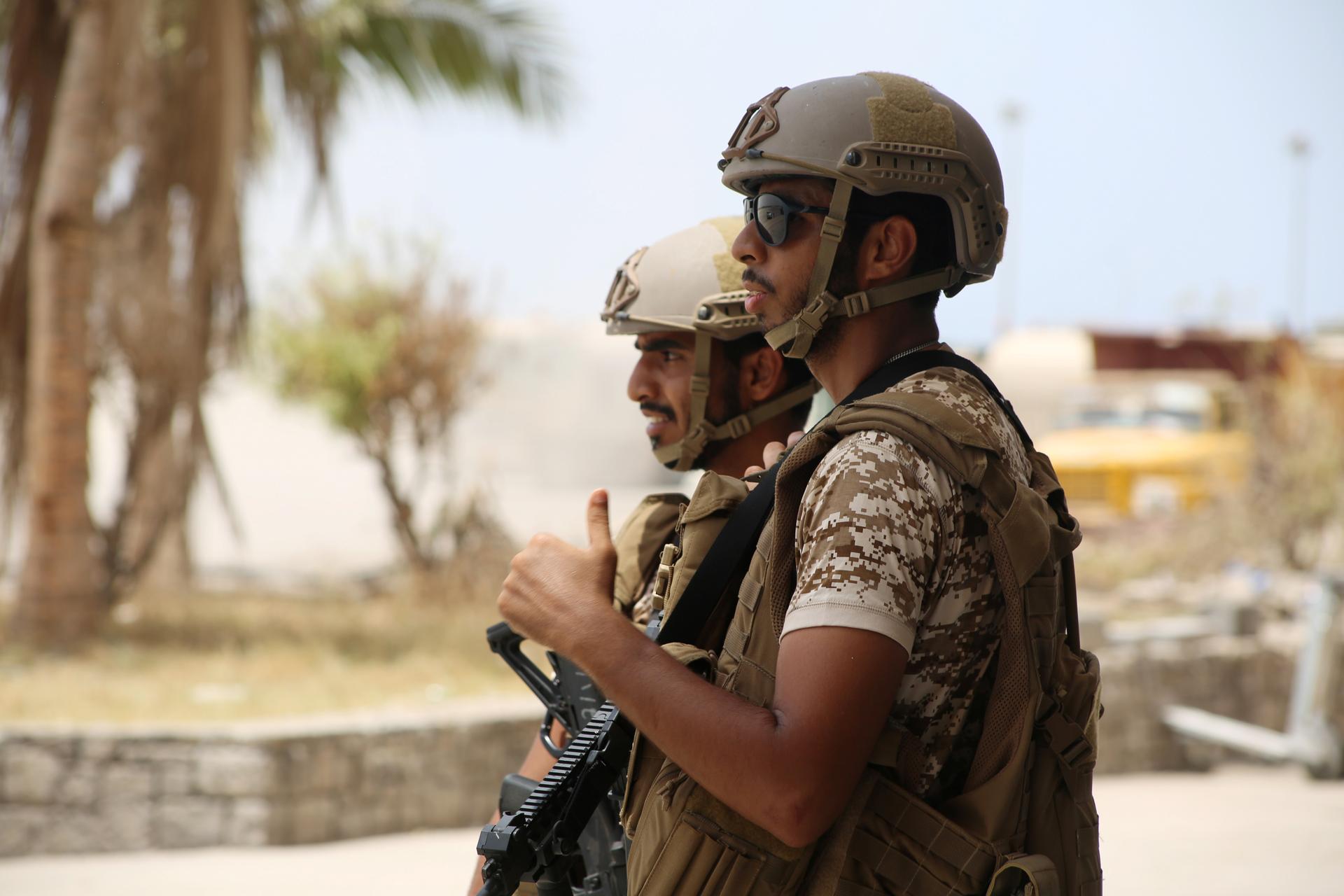 UAE soldiers stand guard at the international airport of the southern port city of Aden, Yemen.