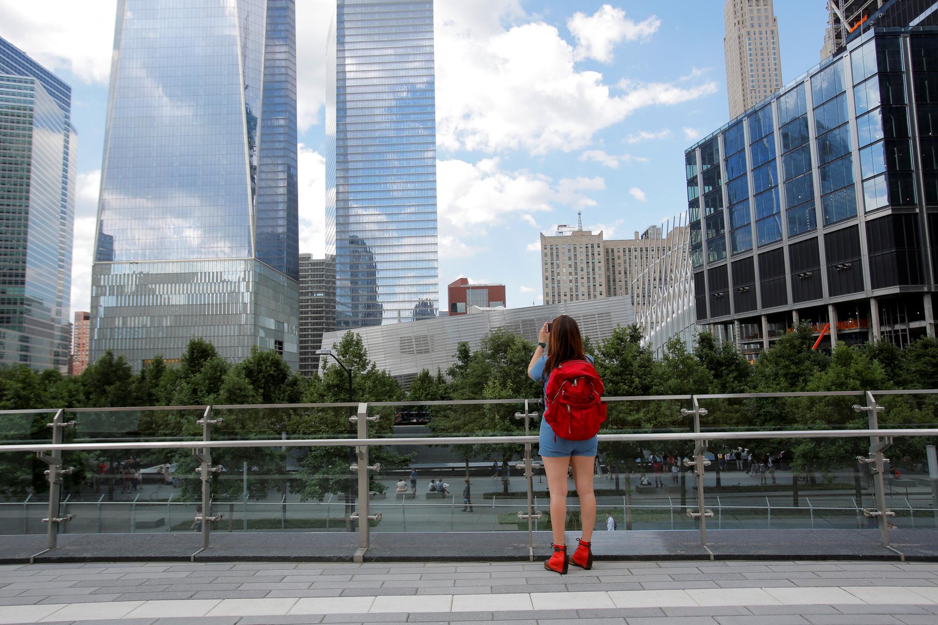 A woman takes a photo from the newly opened Liberty Park above Liberty Street on the World Trade Center site in Manhatten. 