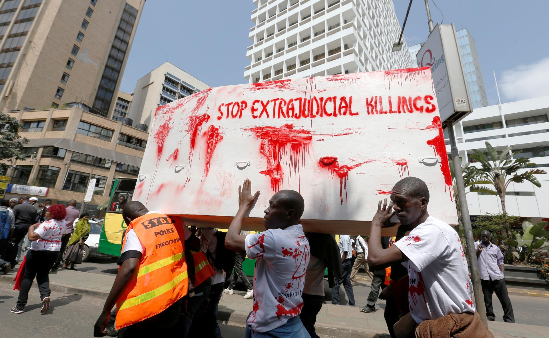 Demonstrators carry a symbol of a coffin stained with red paint as they chant slogans during a protest after the killing of a human rights lawyer, his client and their driver in Nairobi, Kenya, on July 4.
