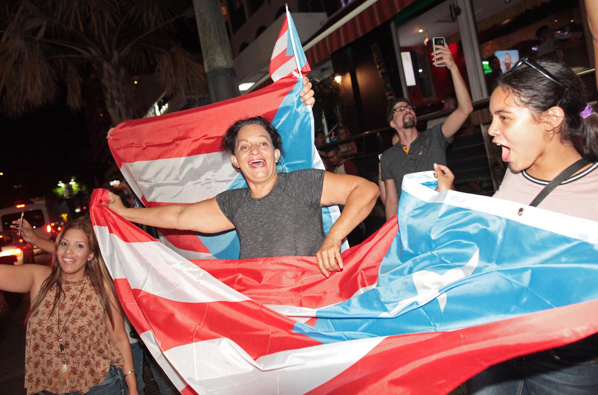 Puerto Ricans celebrate the gold medal won by Monica Puig (PUR) after she beat Angelique Kerber (GER) of Germany in the Rio Olympics. 